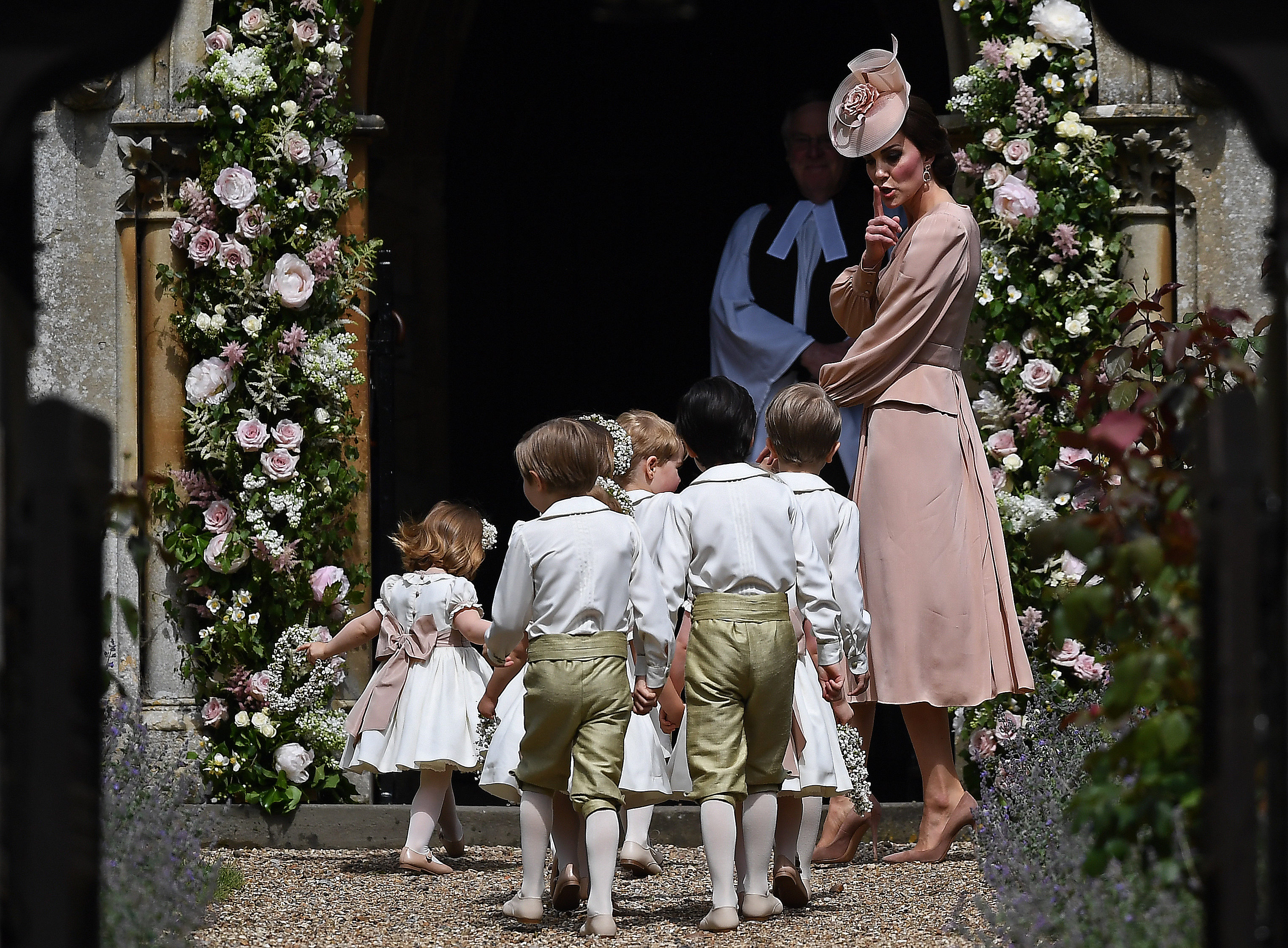 Britain's Catherine, Duchess of Cambridge walks with the bridesmaids and pageboys as they arrive as they arrive for her sister Pippa Middleton's wedding to James Matthews at St Mark's Church on May 20, 2017 in Englefield Green, England. (WPA Pool—Getty Images)