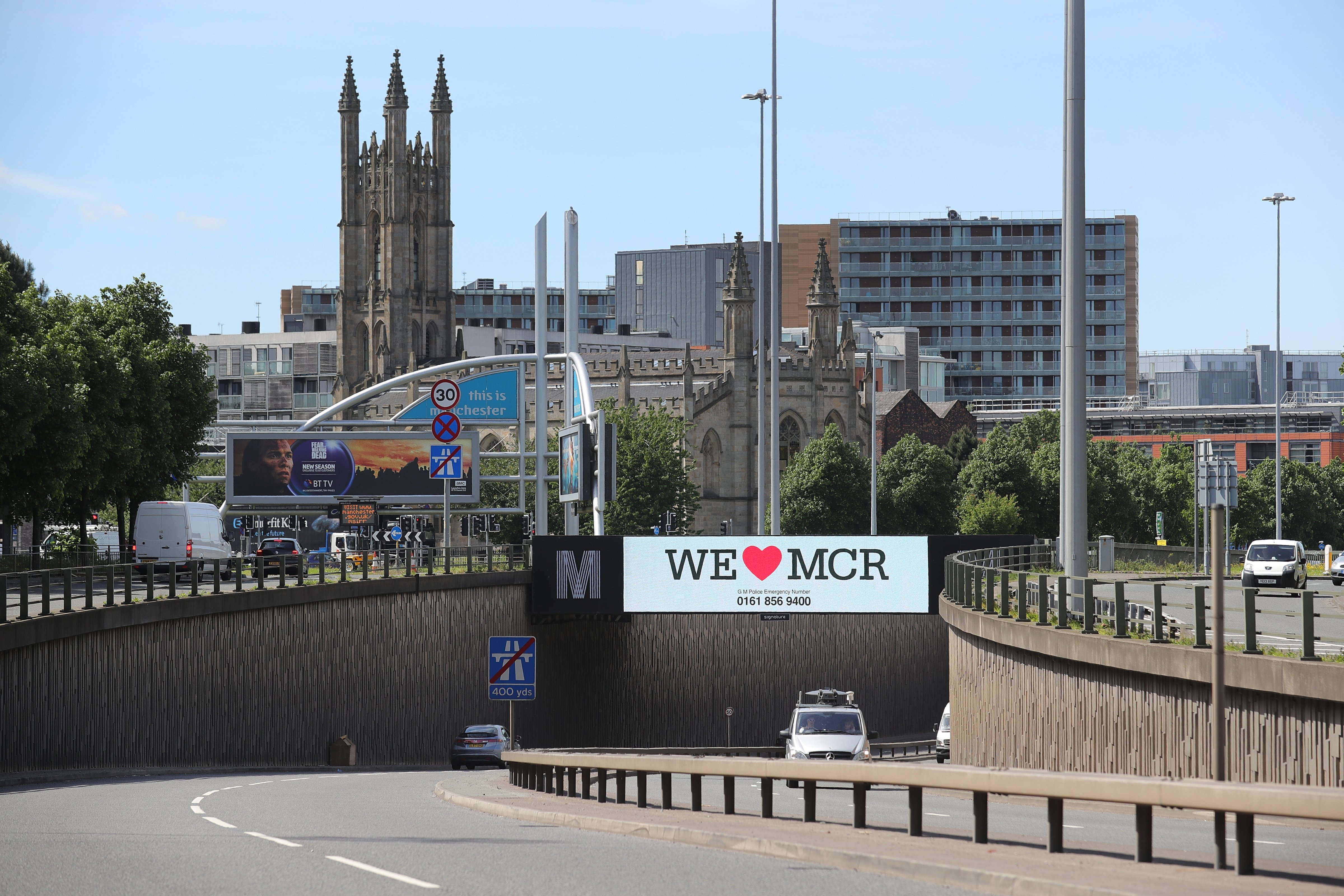 A giant TV screen displays the 'We Love Manchester" logo and police emergency incident telephone number after last nights terrorist attack, May 23, 2017 in Manchester, England. (Christopher Furlong—Getty Images)