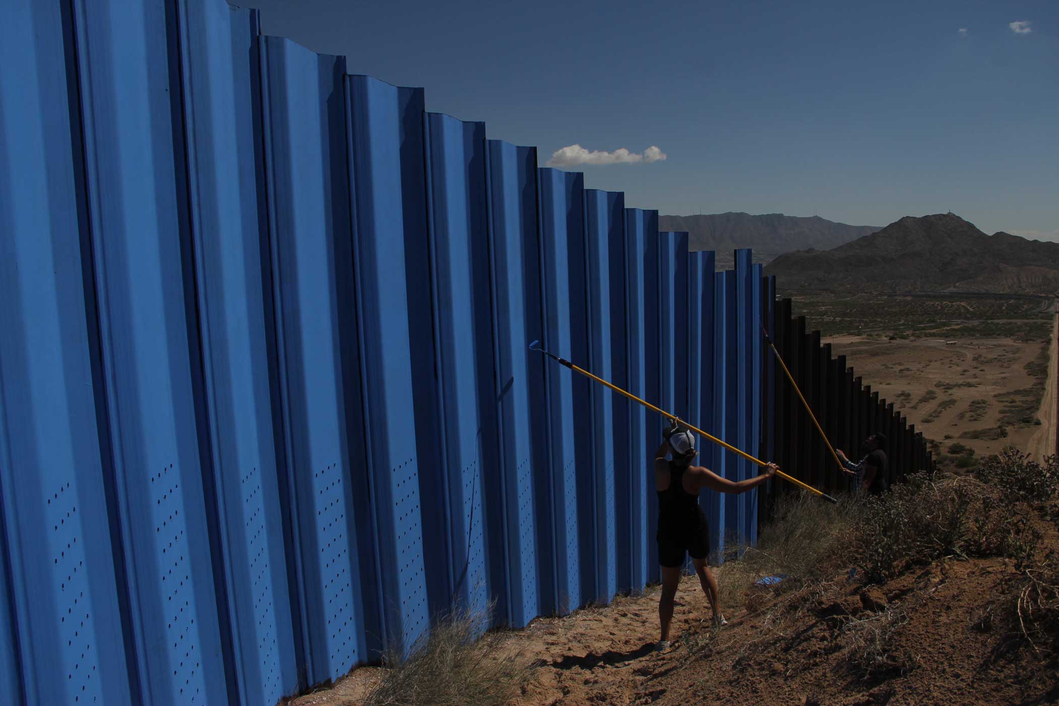 The border wall between Mexico and El Paso, Texas is painted in the Anapra neighborhood outside Ciudad Juarez. A group of local artists decided to paint the wall blue to contrast the sky as part of the  Under the same sky  project.