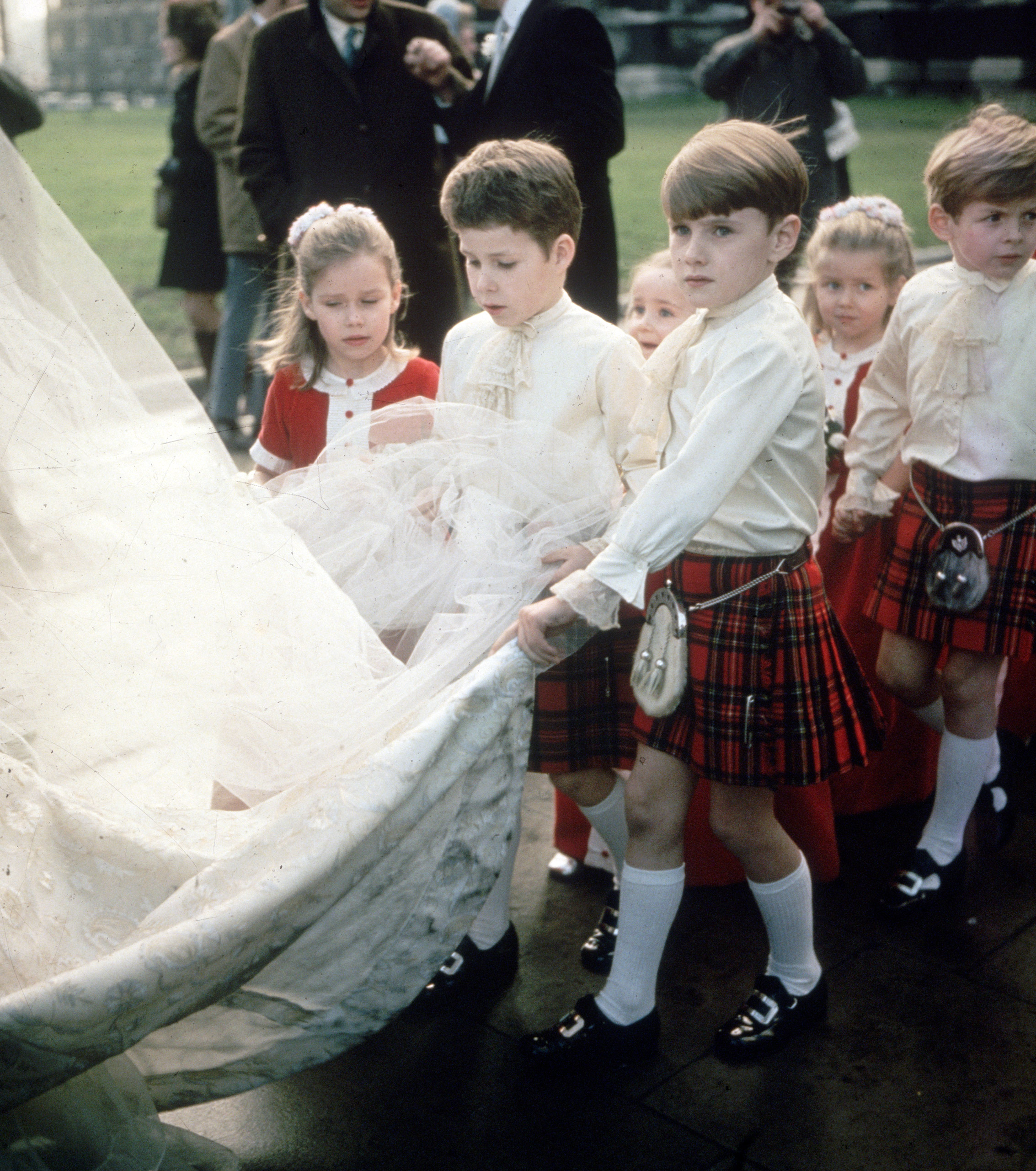 Princess Margaret's children, Viscount David Linley and his sister, Sarah Armstrong-Jones, among the pageboys and bridesmaids at a society wedding. 1975.