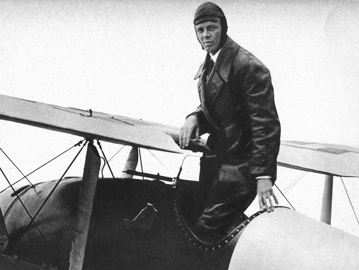 Charles Lindbergh (1902-74) in his flying kit standing in the Spirit of St Louis, the plane in which he made the first non-stop Atlantic air crossing in 1927. (Print Collector / Getty Images)