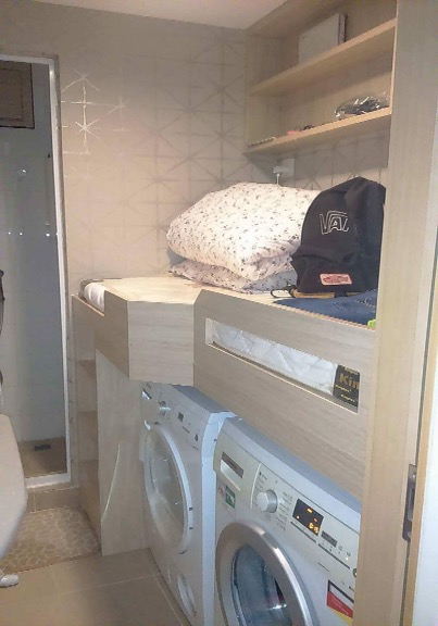 Hong Kong's Mission for Migrant Workers says it was sent this photo by a domestic worker in Hong Kong, showing a bed built above a washing machine and dryer that she alleges is her sleeping area (Handout—Mission for Migrant Workers)