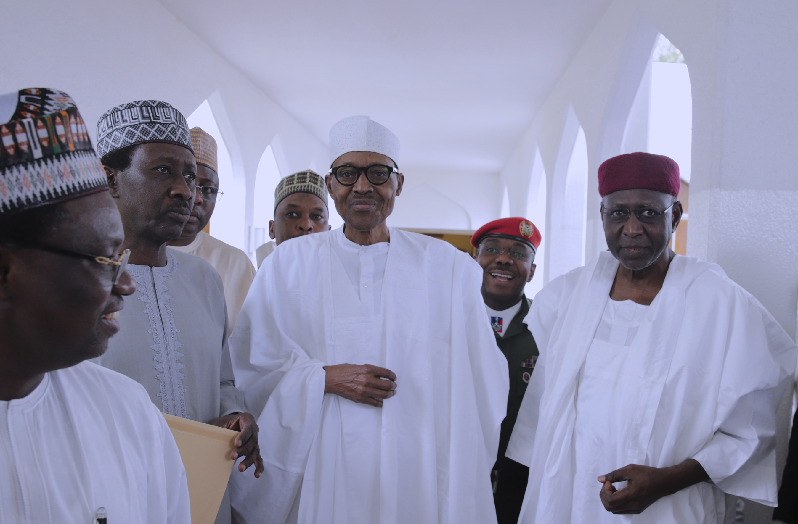 Nigeria's President Muhammadu Buhari with government officials after Friday prayers at the presidential palace in Abuja, Nigeria on May 5, 2017. Nigeria's 74-year old president has emerged to attend Friday prayers after missing a number of public engagements and three straight weekly cabinet meetings because of poor health. (Sunday Aghaeze—Nigeria State House/AP)