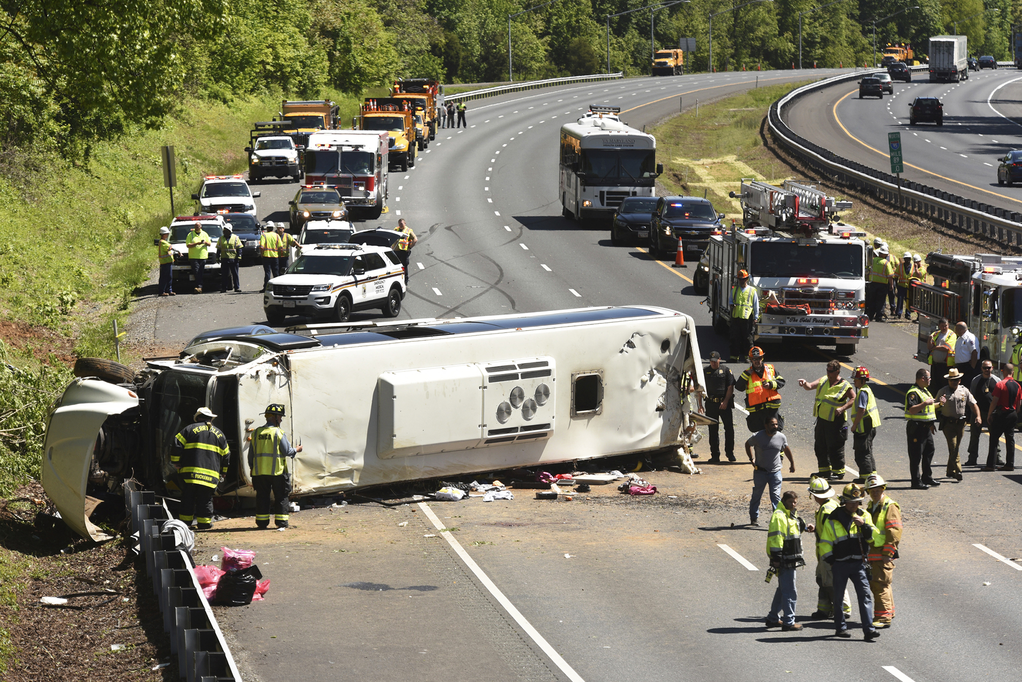 Emergency workers tend to an overturned bus on I-95 southbound in Havre de Grace, Md., on May 15, 2017. (Amy Davis—AP)