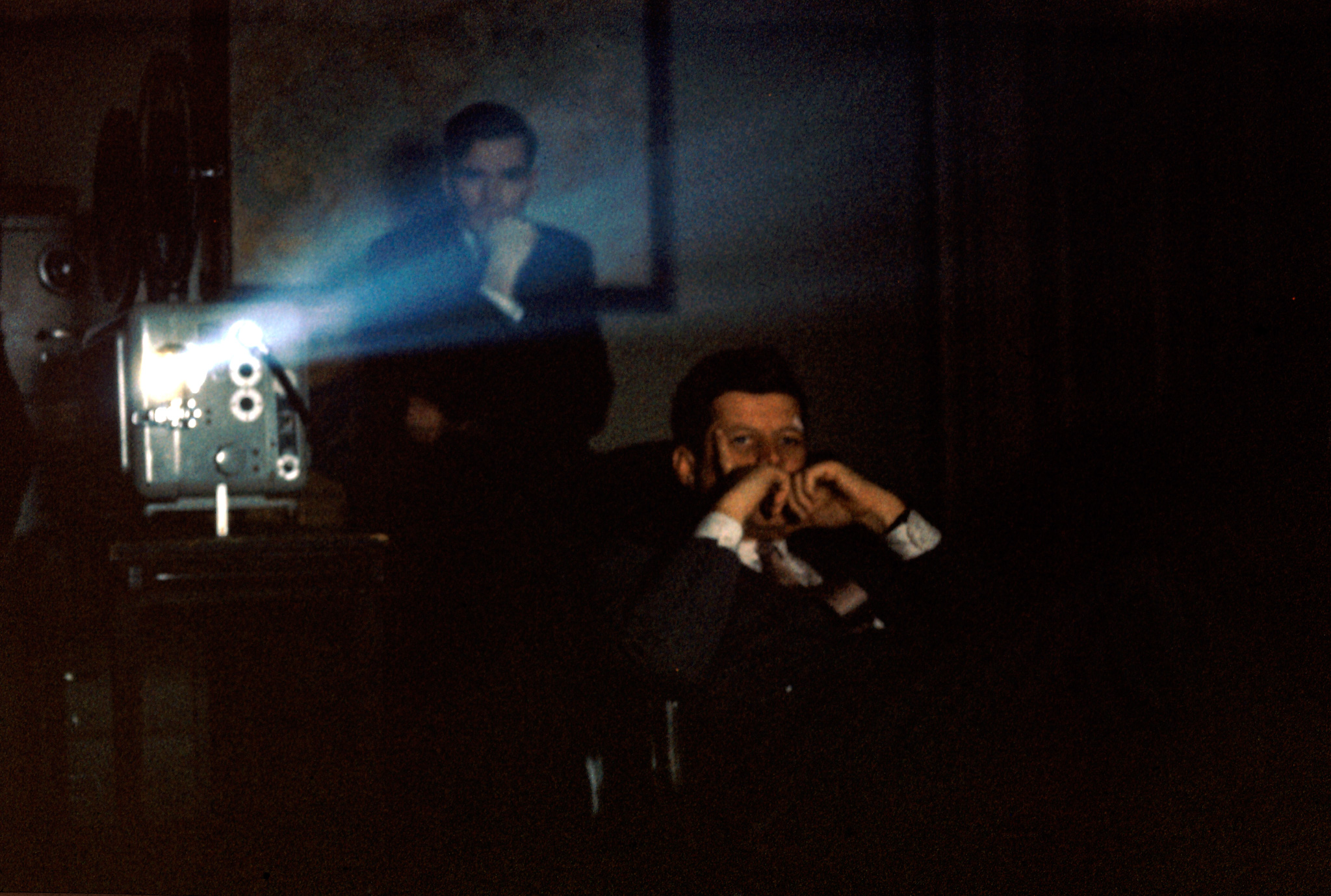 President John F. Kennedy watches a film in Press Secretary Pierre Salinger's office, Feb. 2, 1961.