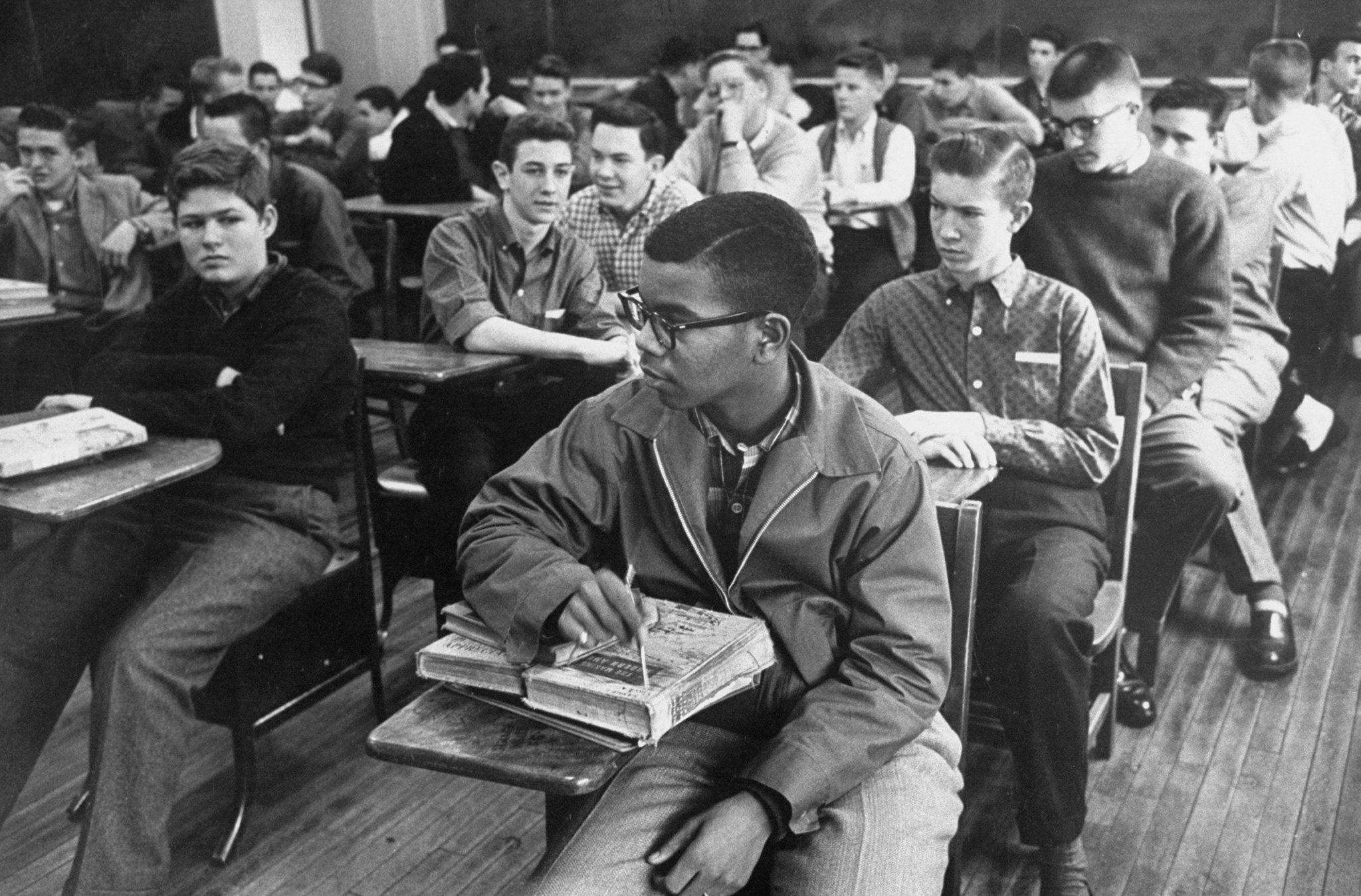 Lewis Cousins (C) sits in class surrounded by white students. Cousins was the first black student to attend the newly desegregated Maury High School in Norfolk, Va, 1959.