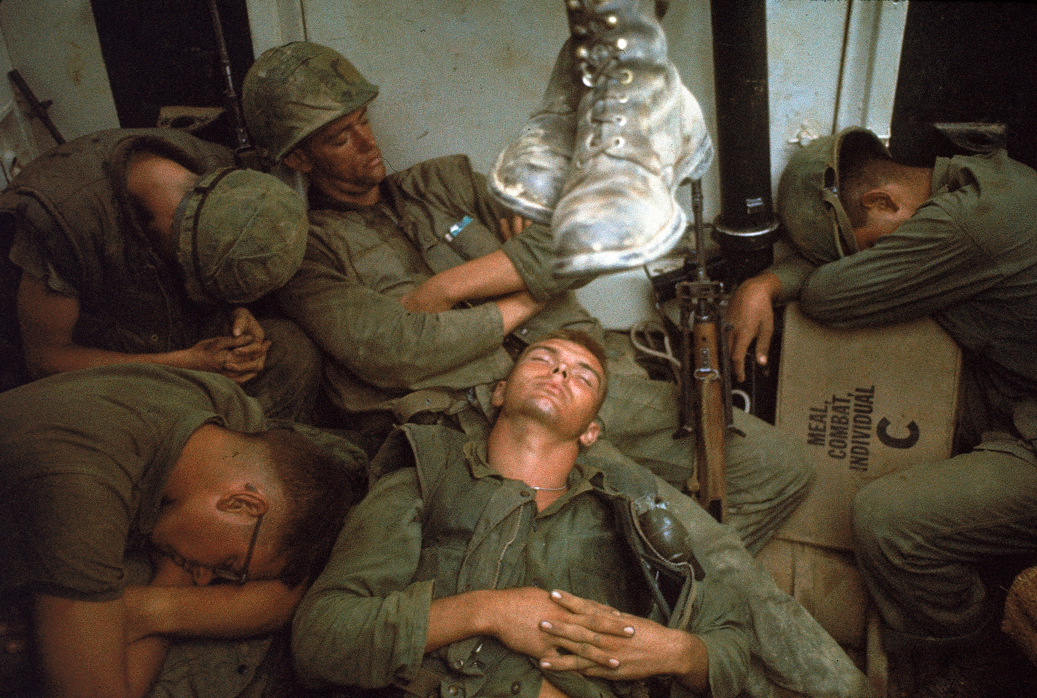 Weary American Marines of 7th Regiment catch some sleep following intense fighting in the area around Cape Batangan during the Vietnam War, November 1965. Marines fought from dawn until dark in temperatures that reached 130 degrees before they secured the beachhead.