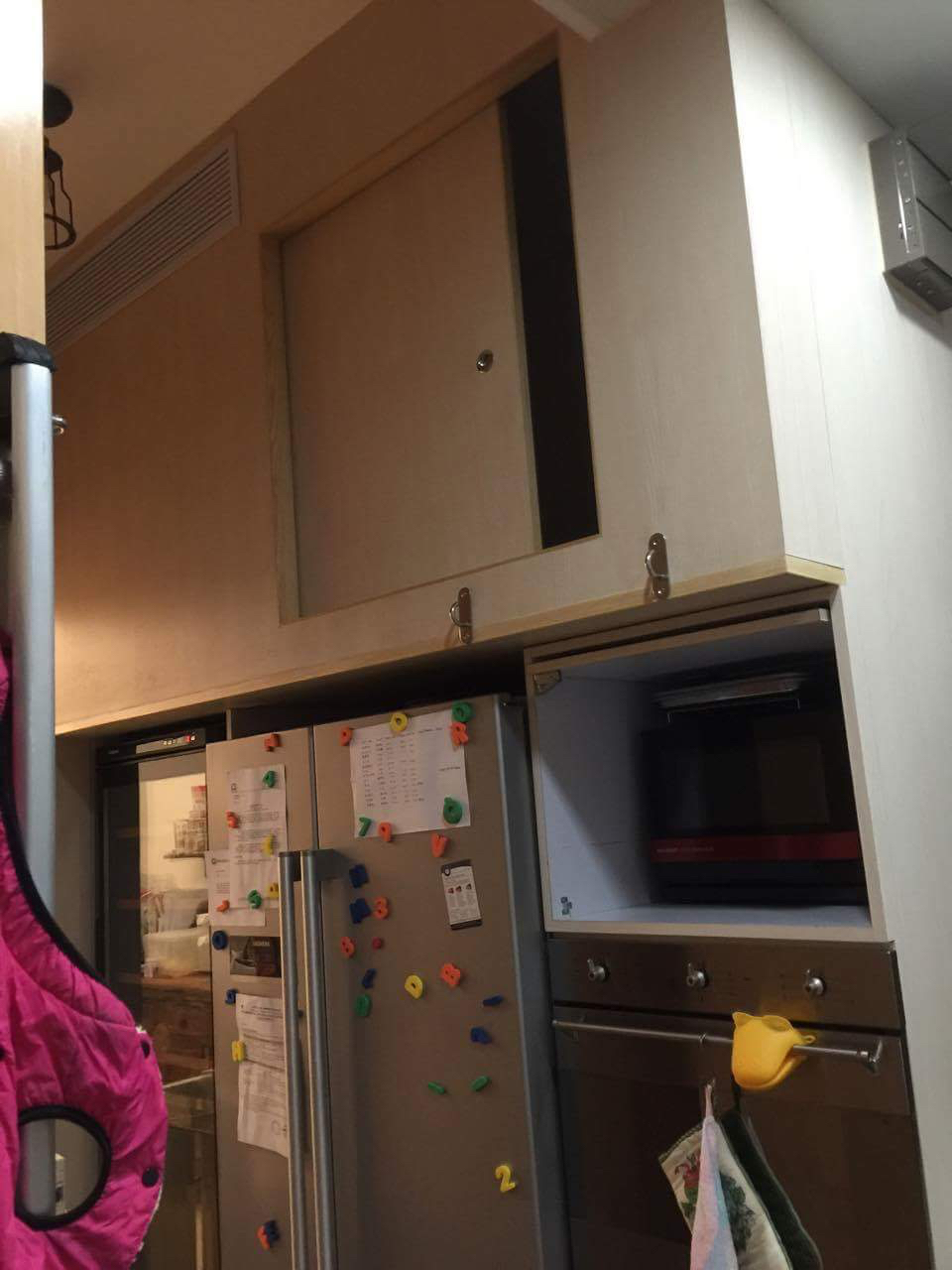 Hong Kong's Mission for Migrant Workers says it was sent this photo by a domestic worker in Hong Kong, showing a cubbyhole above a fridge that she alleges is her sleeping area (Handout—Mission for Migrant Workers)