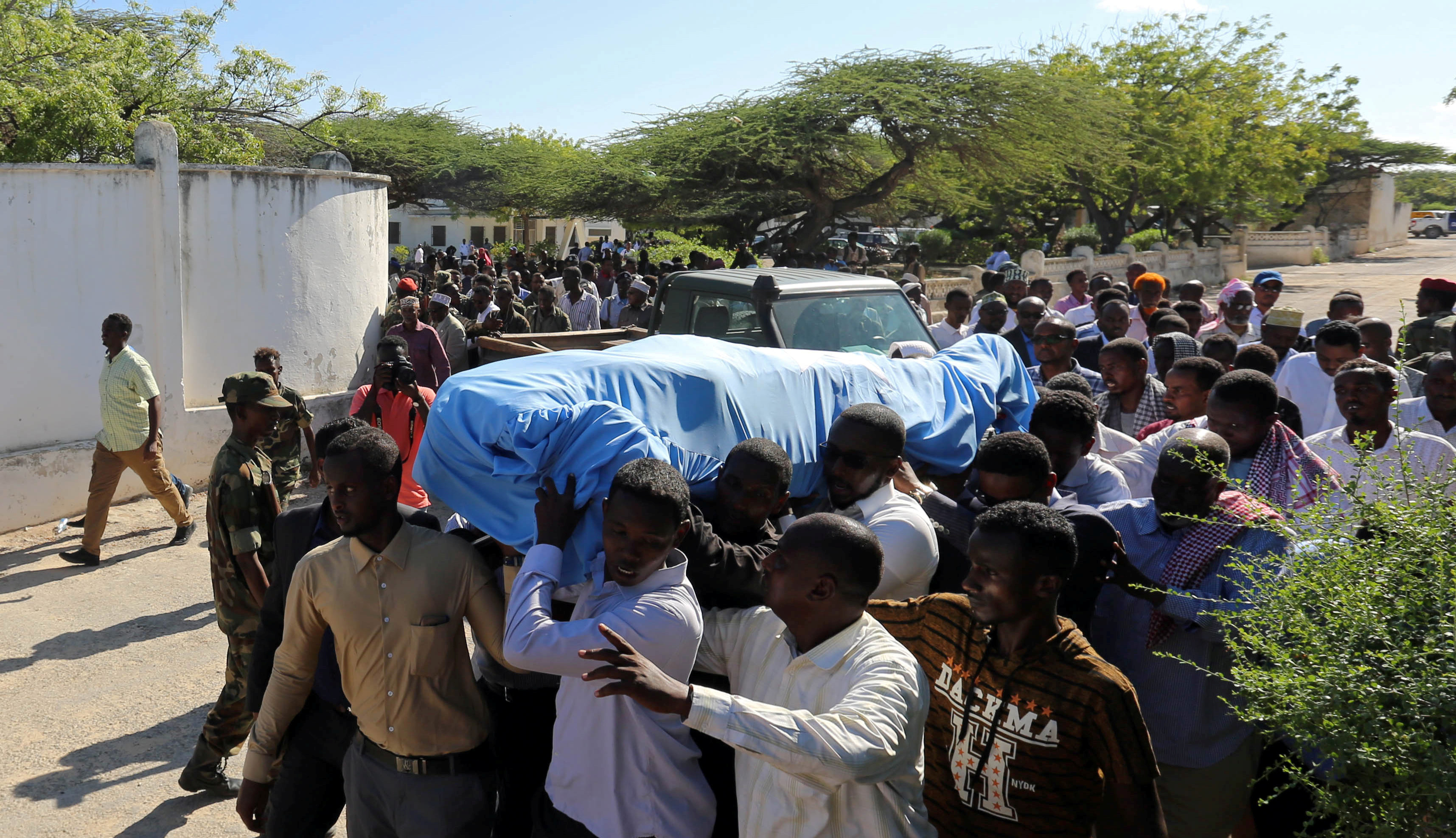 Relatives carry the dead body of Somalia's public works minister Abbas Abdullahi Sheikh Siraji who was shot and killed in the capital Mogadishu