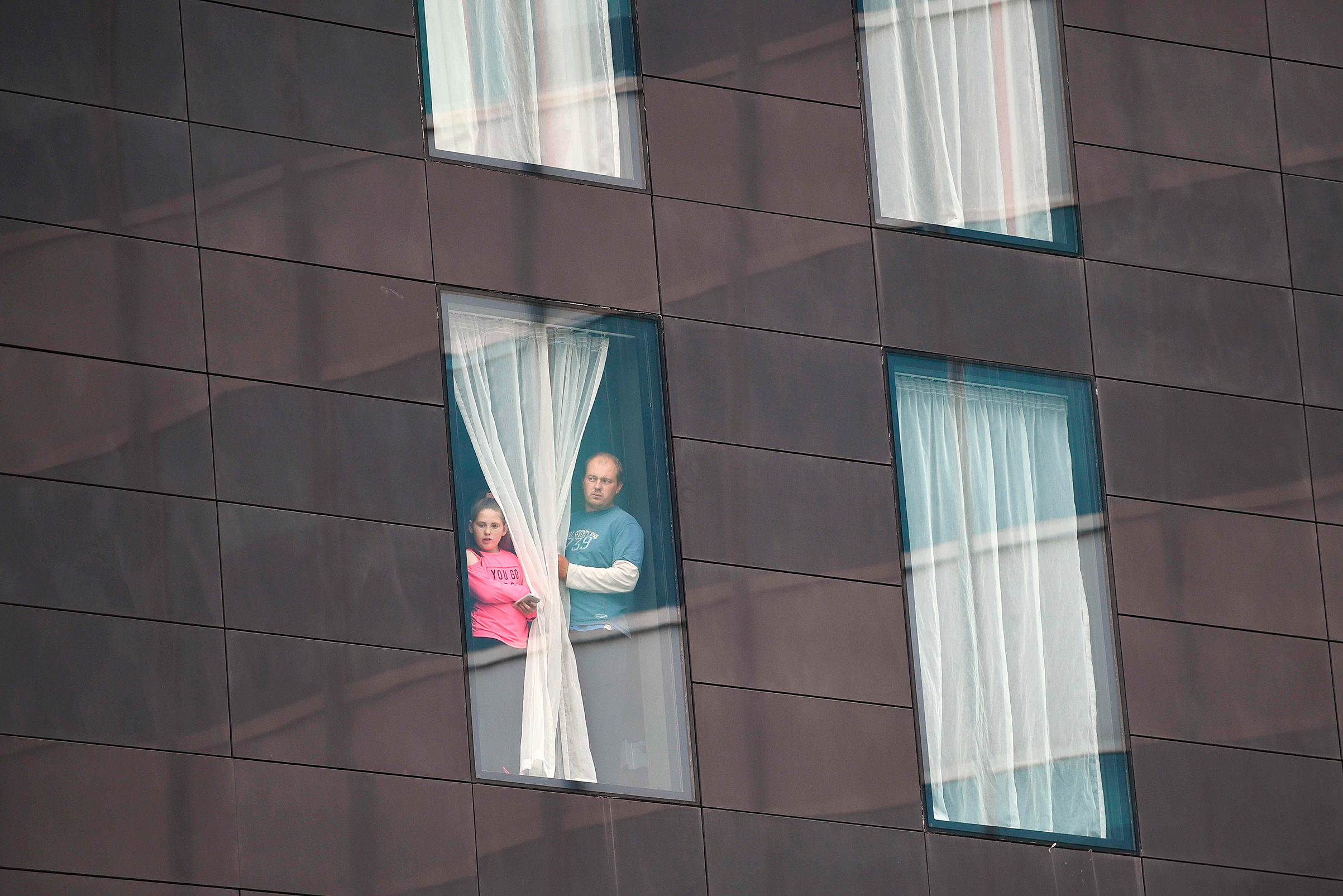 People affected by the May 22 terrorist attack in Manchester looked out from a hotel window (Oli Scarff—AFP/Getty Images)