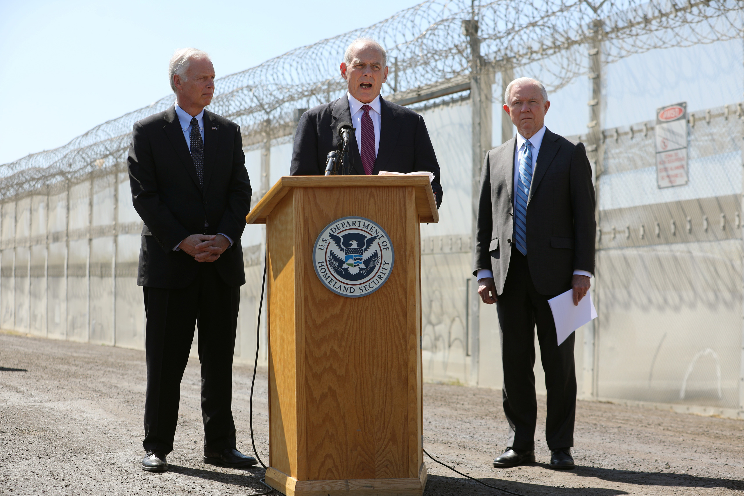 Secretary of Homeland Security John Kelly speaks as Attorney General Jeff Sessions and U.S. Senator Ron Johnson, Chairman of the Senate Committee on Homeland Security and Governmental Affairs listen during visit to the U.S. Mexico border fence in San Diego on April 21, 2017. (Mike Blake—Reuters)