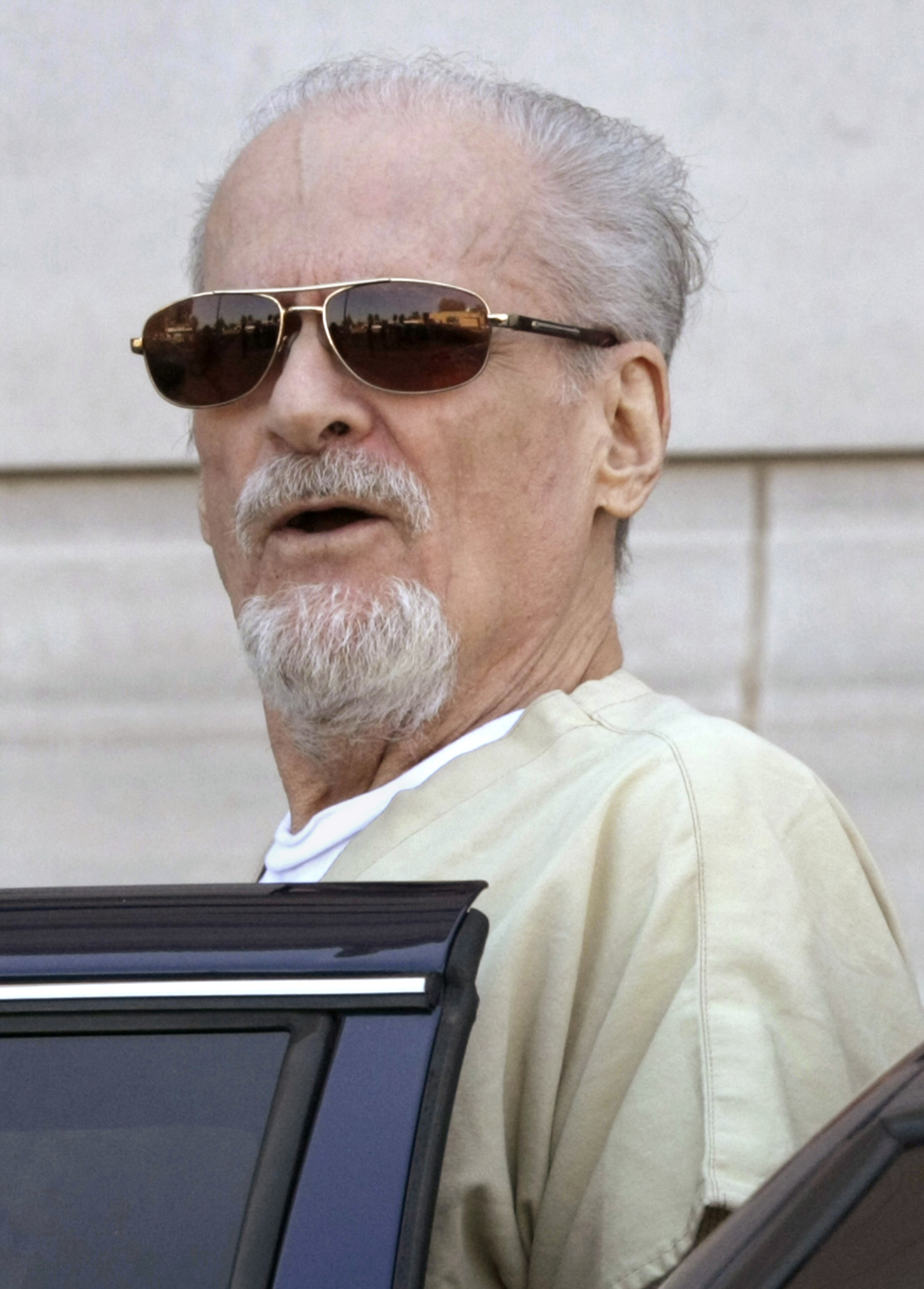 Tony Alamo talks to reporters as he is escorted to a waiting police car outside the federal courthouse in Texarkana, Ark. on July 23, 2009. (Danny Johnston—AP)