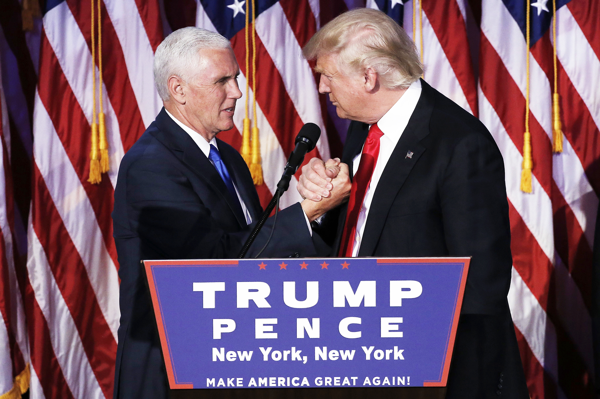 U.S. President-elect Donald Trump greets his running mate Mike Pence during his election night rally in Manhattan
