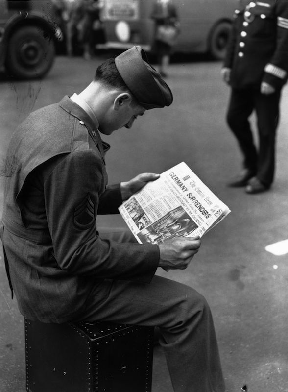 An American soldier in London reads the news of the German surrender at the end of World War II. (J. Wilds—Getty Images)