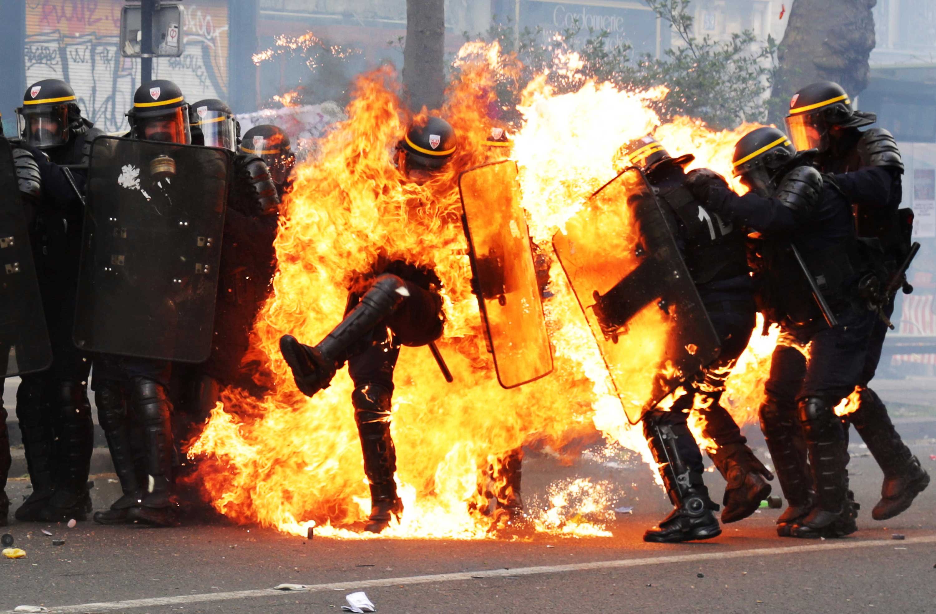 French CRS anti-riot police officers are engulfed in flames as they face protesters during a march for the annual May Day workers' rally in Paris on May 1, 2017. (Zakaria Abdelkafi—AFP/Getty Images)