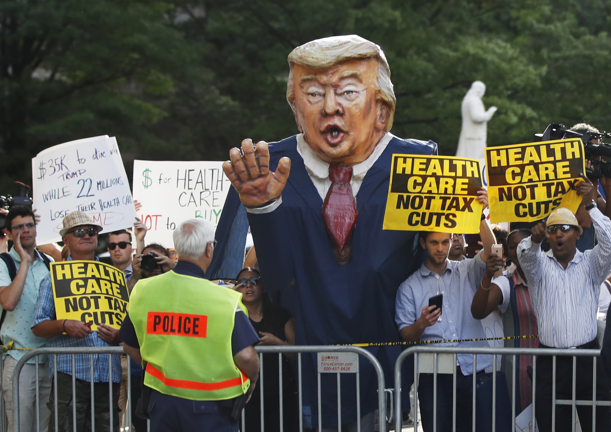 Protesters gather outside the Trump International Hotel in Washington, June 28, 2017, as President Donald Trump arrives at the hotel for fundraiser. (Manuel Balce Ceneta—AP)