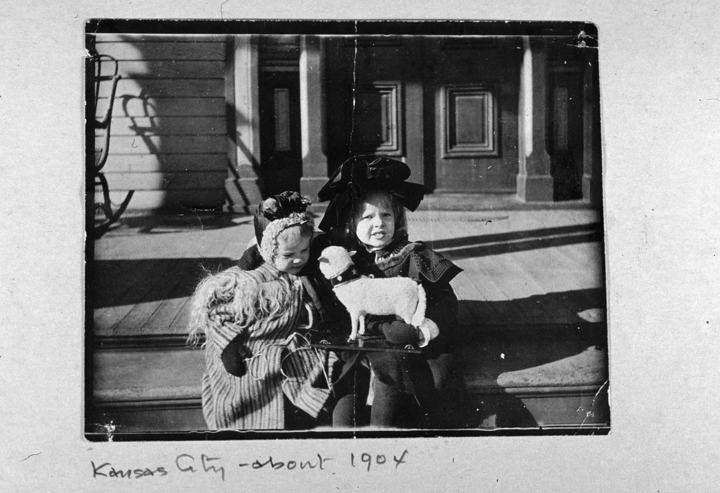 Baby picture of pilot Amelia Earhart with a dog, a toy sled, and her cousin Otis Balis, Kansas City. 1904.