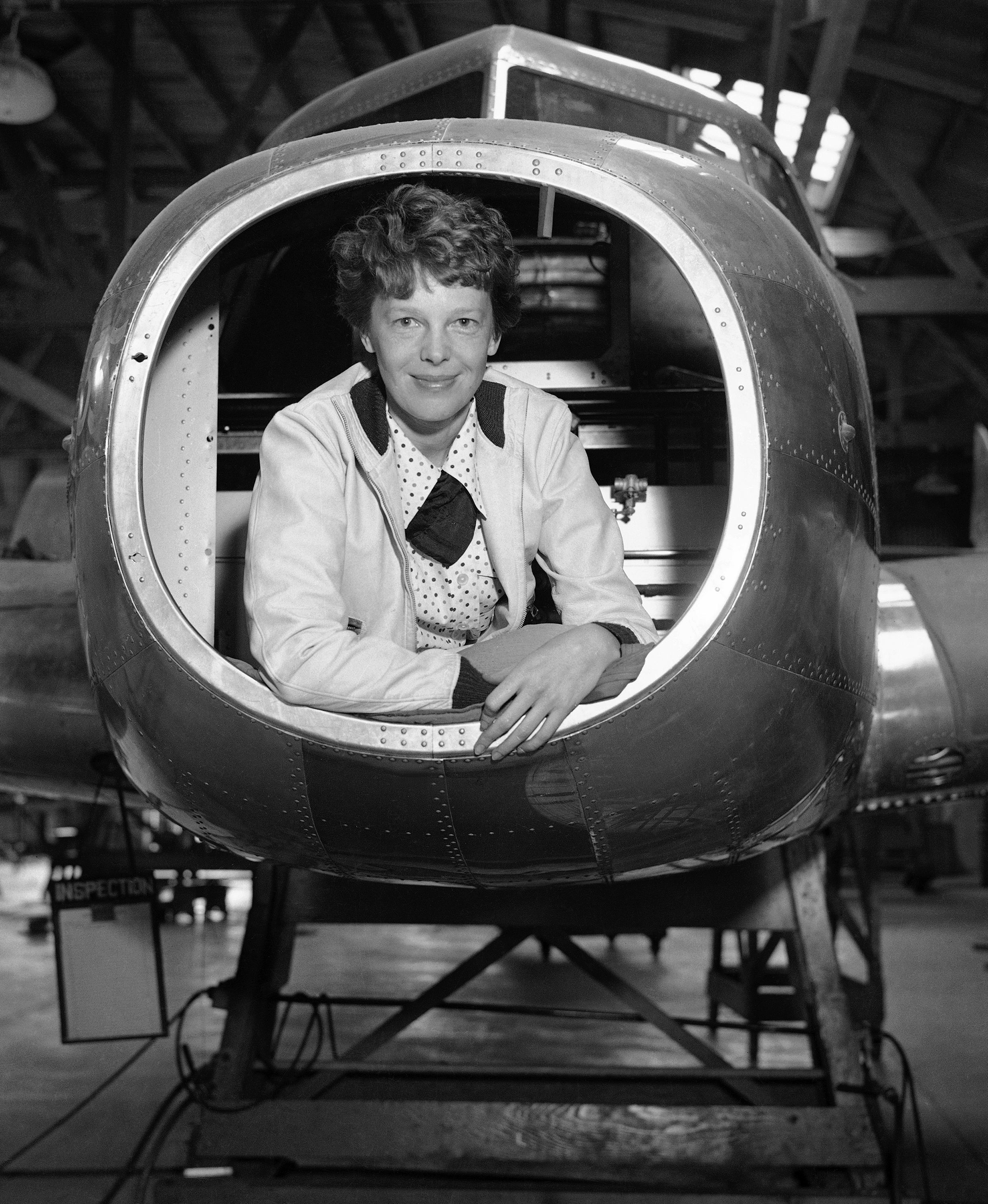 Amelia Earhart inspected the Twin-Engined Lockheed Electra Monoplane which is being built for her use in future long distance flights at the plant, May 26, 1936, Burbank, Calif.