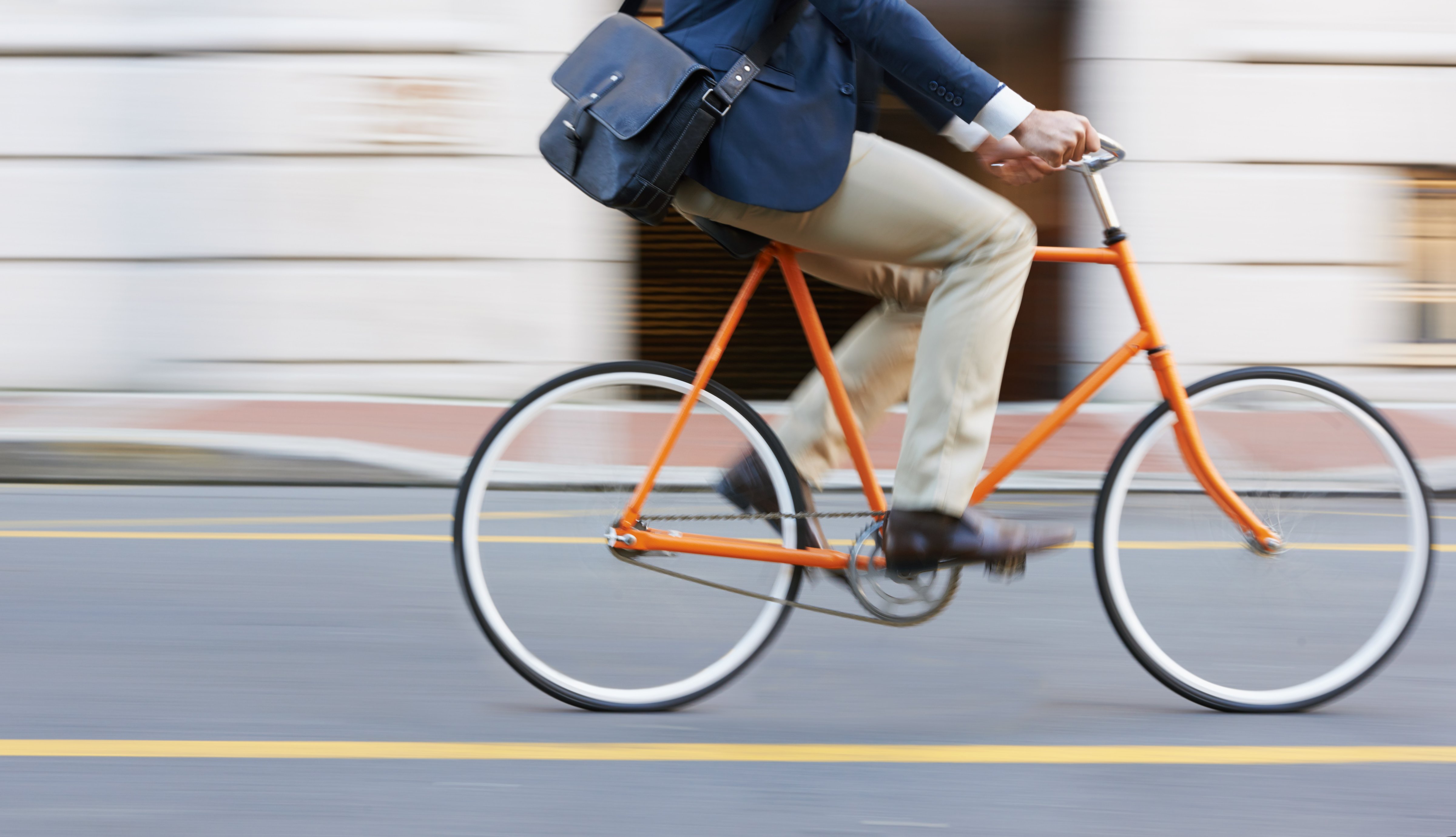 Cropped shot of a man riding his bicycle through the city (Getty Images)