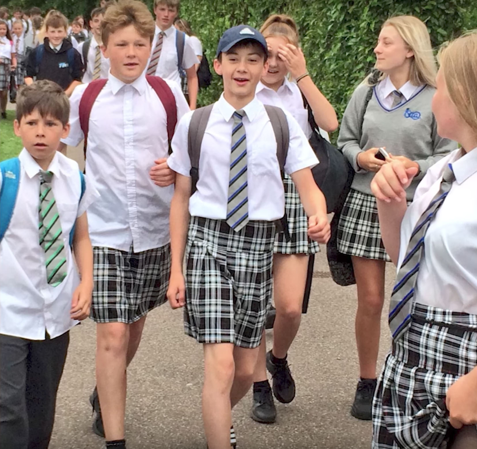 Male students at the Isca Academy in Exeter, England, wear skirts in protest of the school's shorts ban on June 22, 2017. (Youtube)