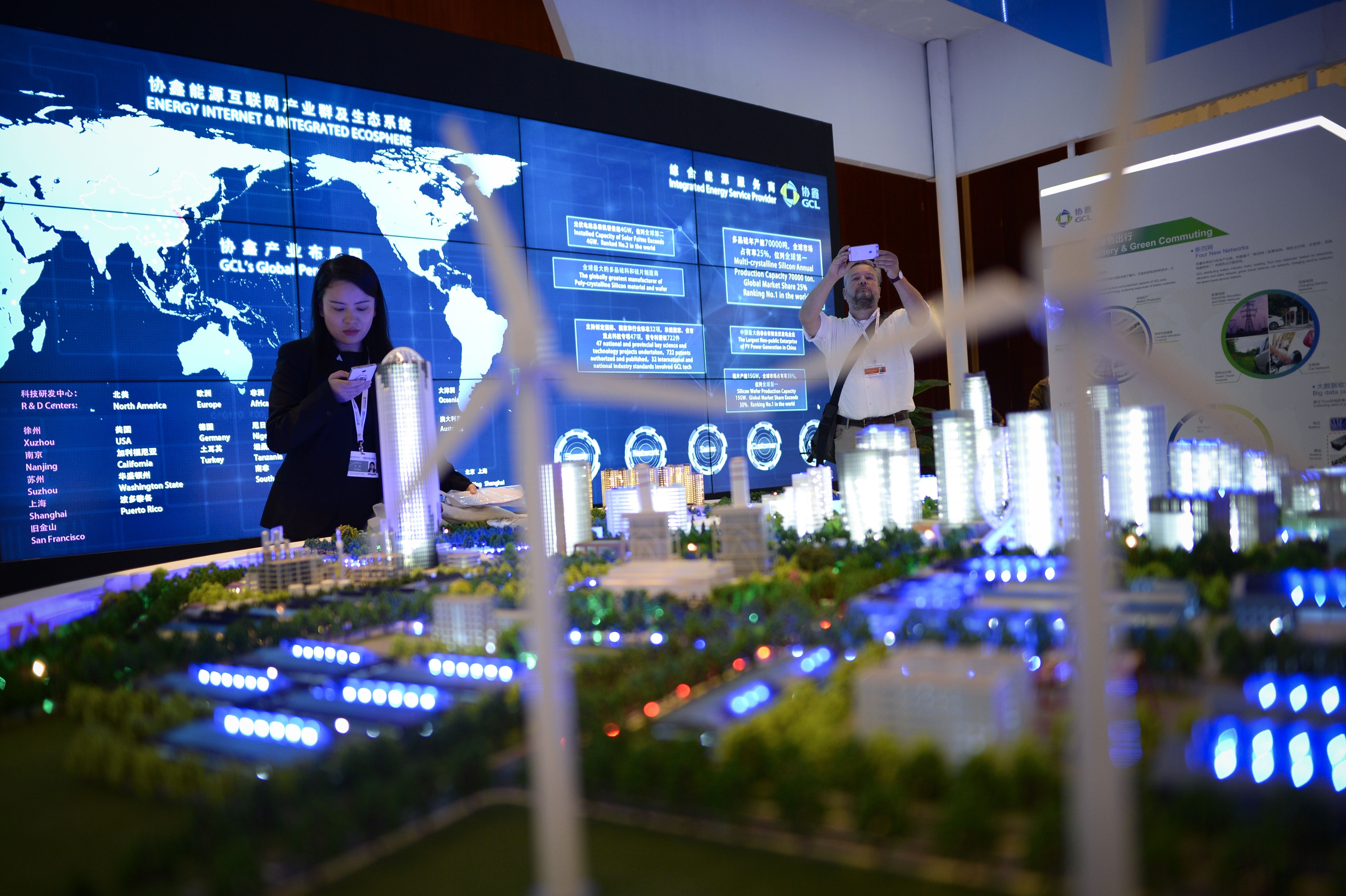 People visit a clean energy exhibition on the sidelines of the Clean Energy Ministerial international forum in Beijing on June 6, 2017.
                      Officials and business leaders from around the world have gathered for the clean energy ministerial meeting in the Chinese capital. (Wang Zhao—AFP/Getty Images)