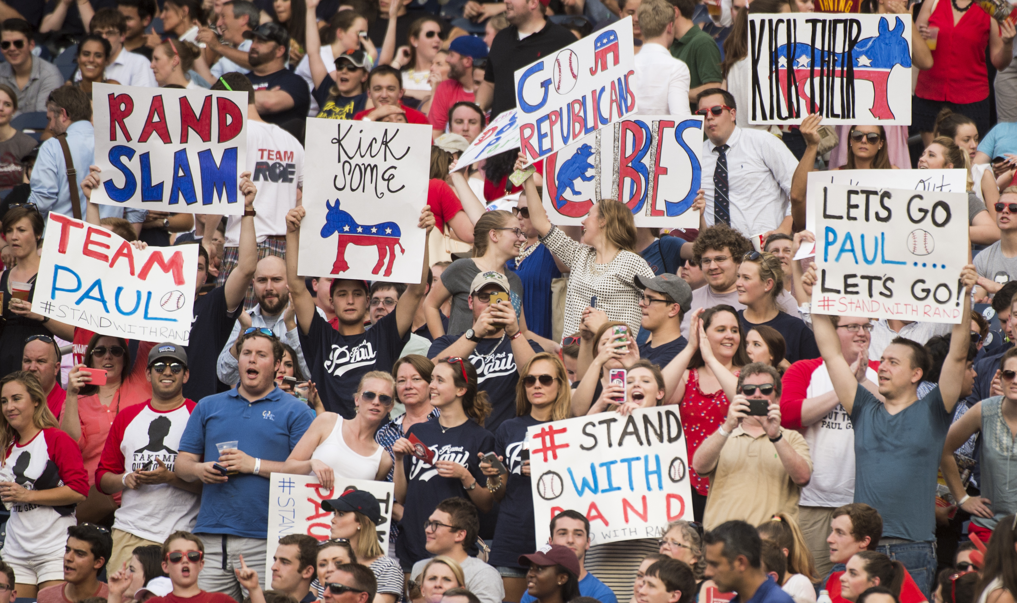 Sen. Rand Paul fans cheer and wave posters in the stands as Sen. Paul bats during the 54th Annual Roll Call Congressional Baseball Game at Nationals Park in Washington on June 11, 2015. The Democrats beat the Republicans 5-2. (Bill Clark—Getty Images)