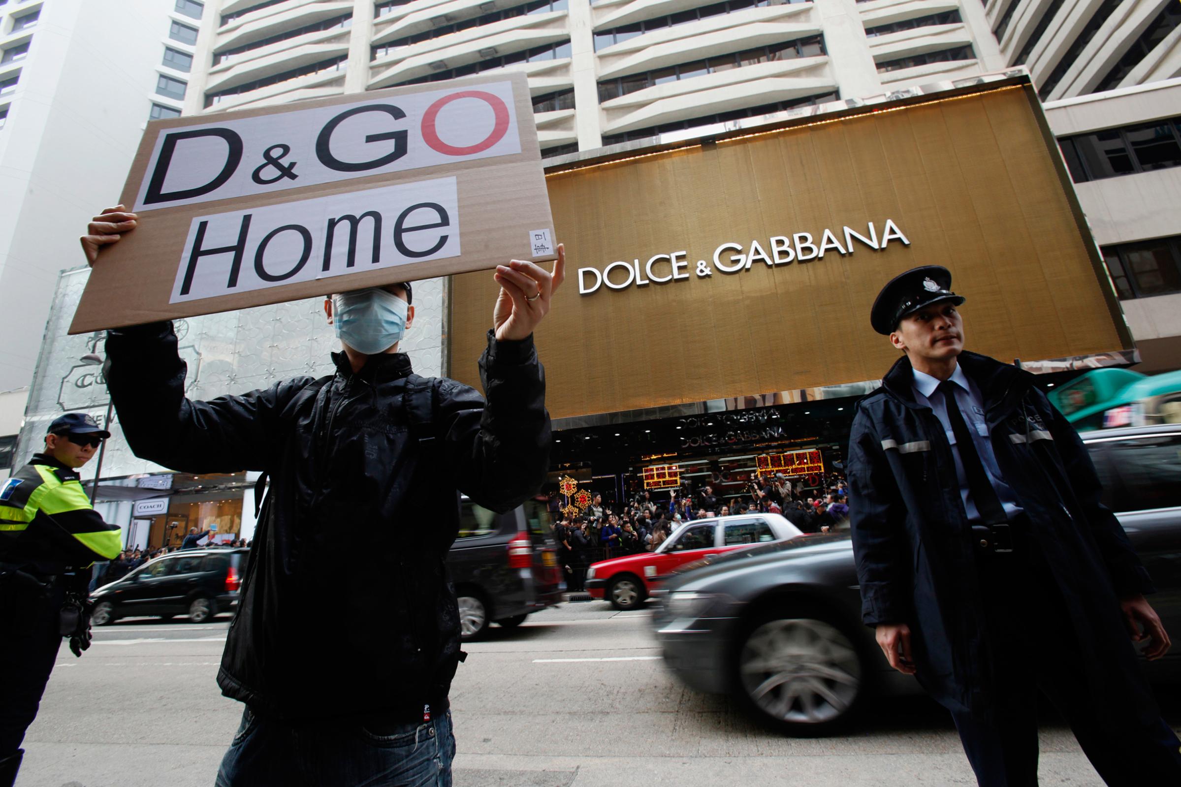 A protester holds a placard outside the flagship store of Dolce & Gabbana in Hong Kong on Jan. 8, 2012.