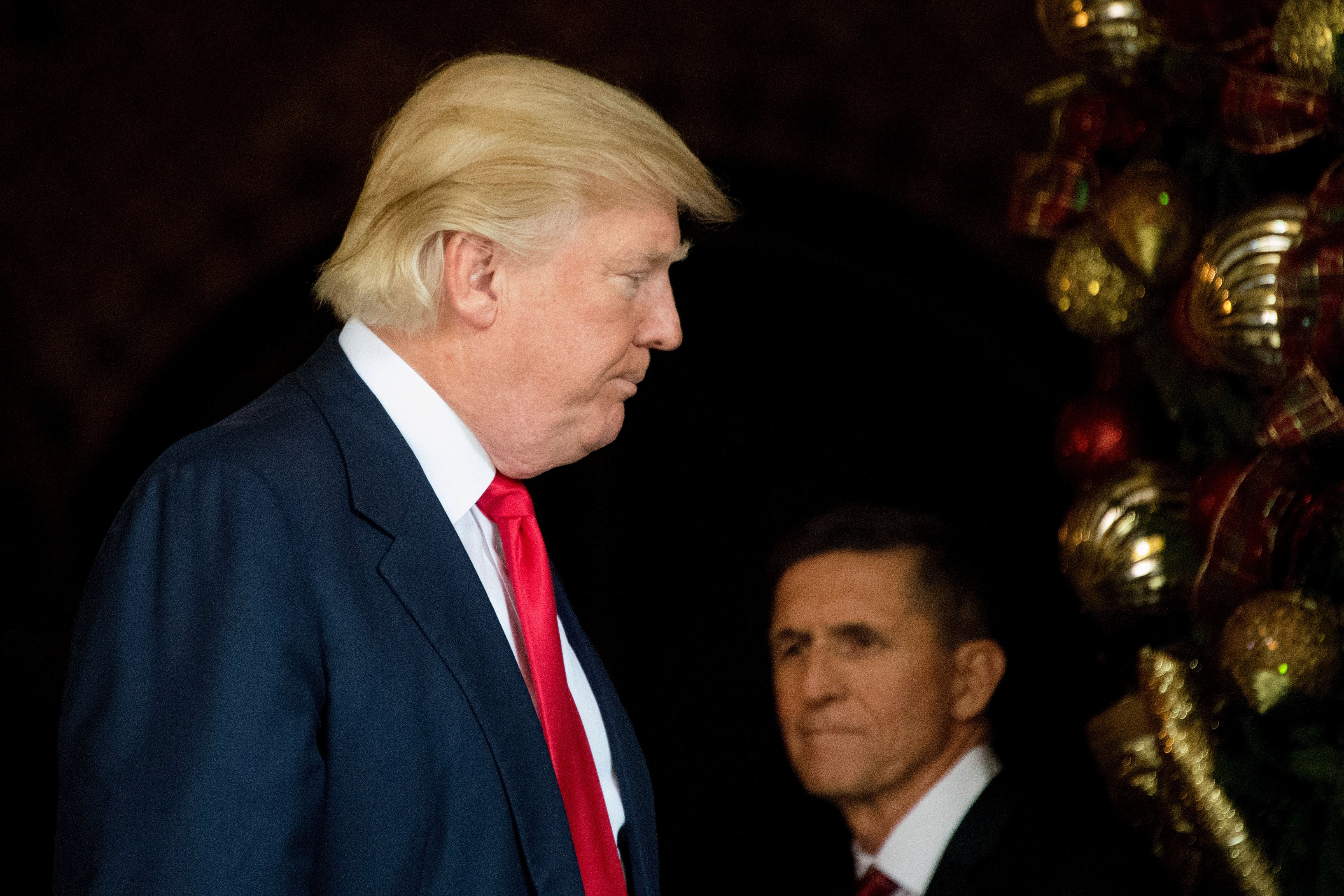 Donald Trump (L) stands with Trump National Security Adviser Lt. General Michael Flynn (R) at Mar-a-Lago in Palm Beach, Florida, on Dec. 21, 2016. (JIM WATSON&mdash;AFP/Getty Images)