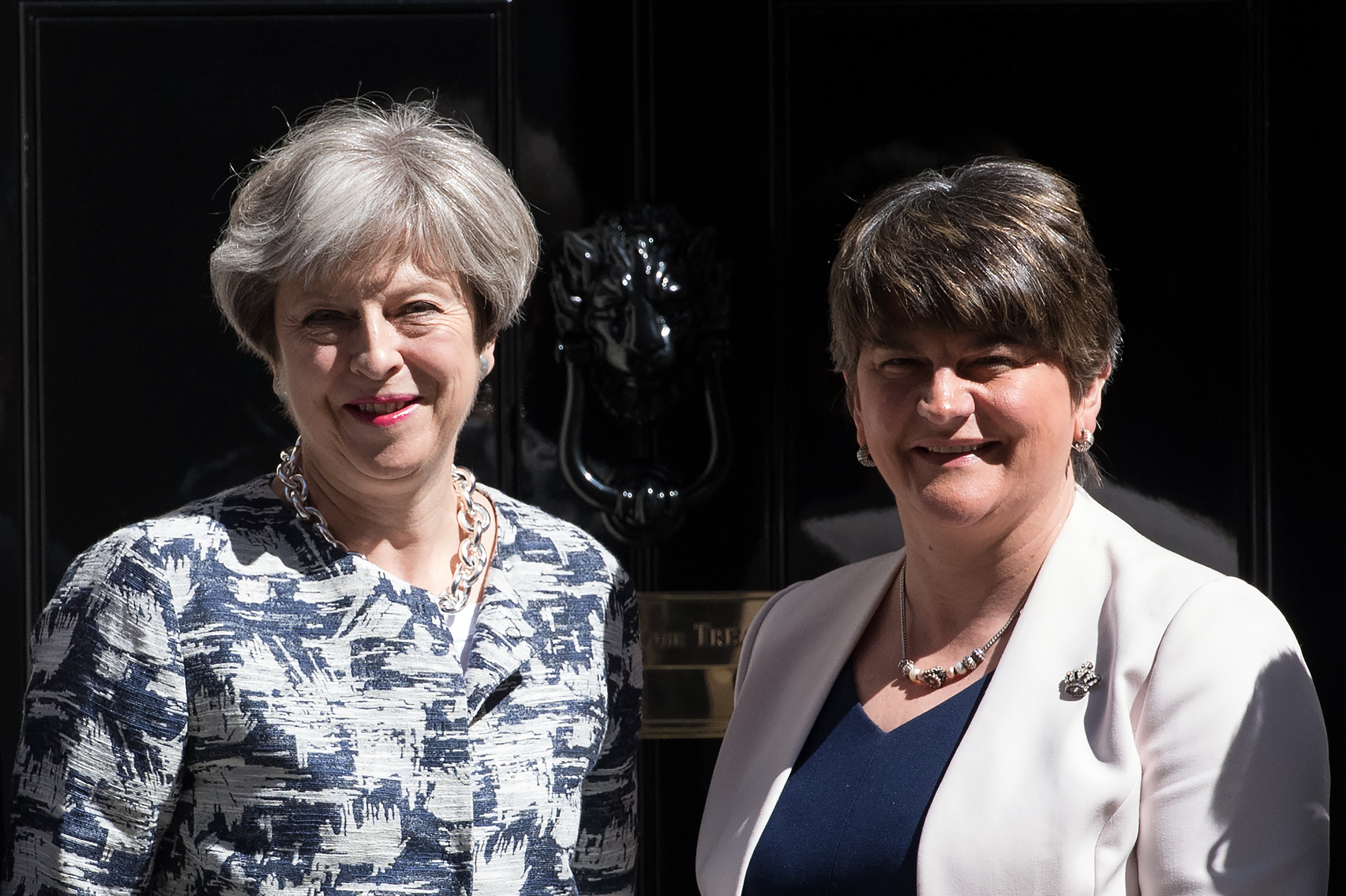 Britain's Prime Minister, Theresa May (L), greets Arlene Foster, the leader of Northern Ireland's Democratic Unionist Party in Downing Street on June 26, 2017 in London, England.