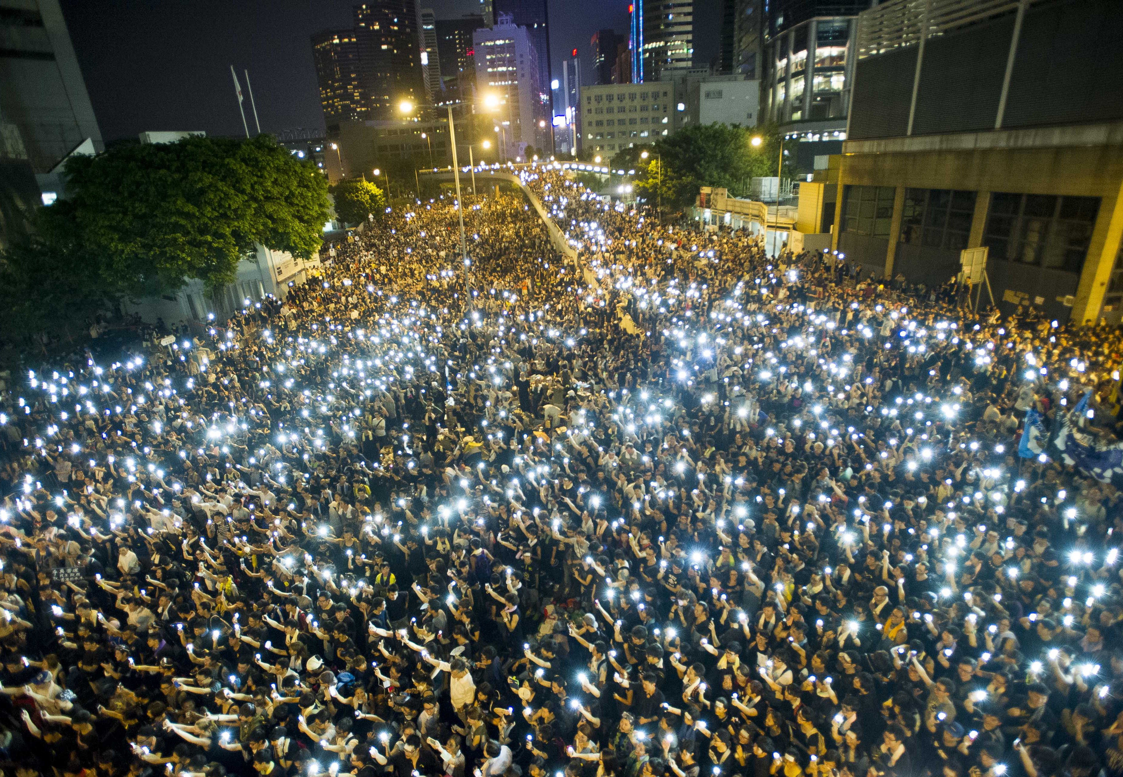 Protestors hold up their cellphones in a display of solidarity during a protest outside the headquarters of Legislative Council in Hong Kong on Sept. 29, 2014. (Xaume Olleros—AFP/Getty Images)