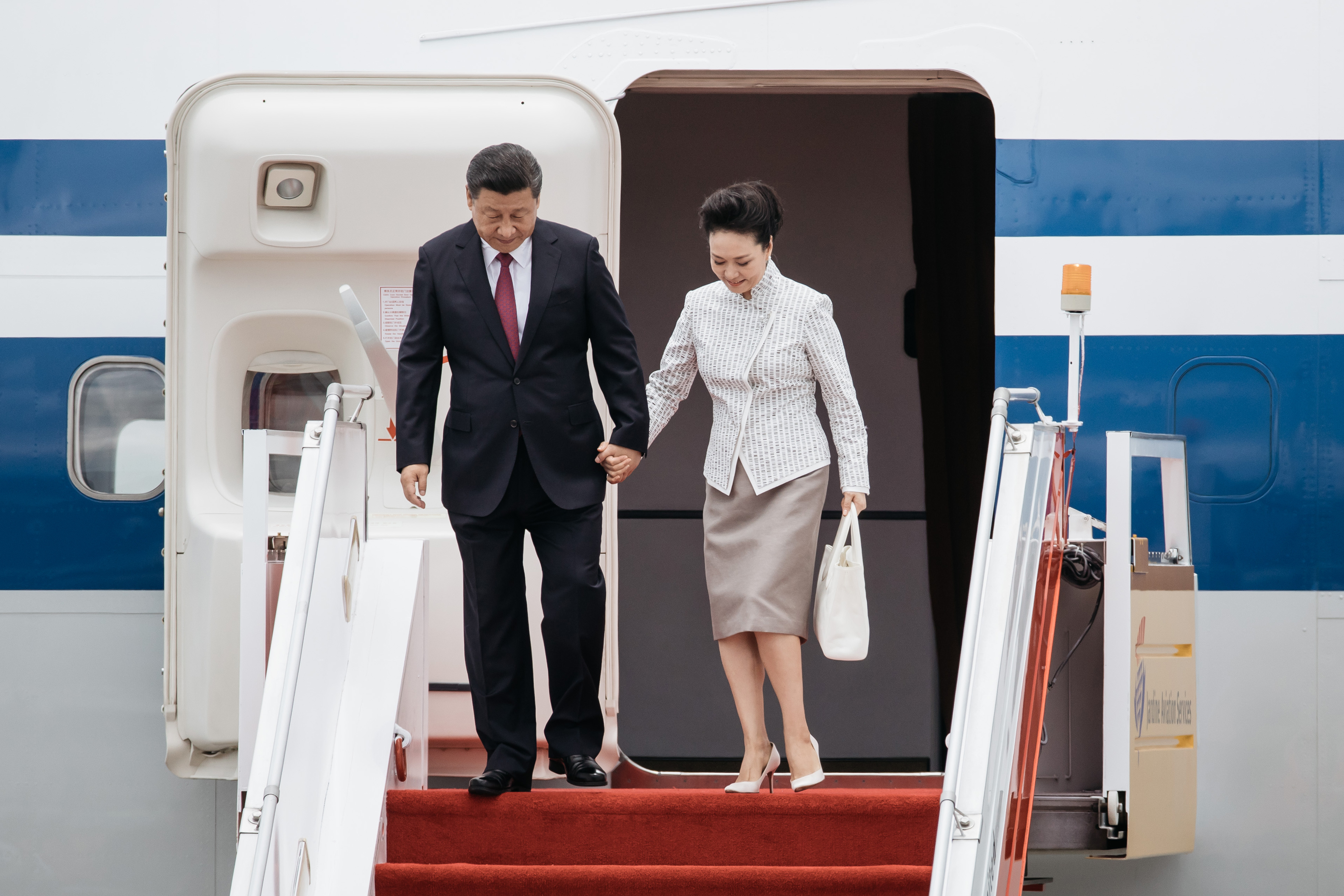 Xi Jinping, China's president, left, and Peng Liyuan, China's first lady, disembark from a plane at Hong Kong International Airport in Hong Kong, China, on Thursday, June 29, 2017. Xi arrived Thursday for his first visit to the financial hub since becoming China's top leader in 2012. (Anthony Kwan/Bloomberg via Getty Images)