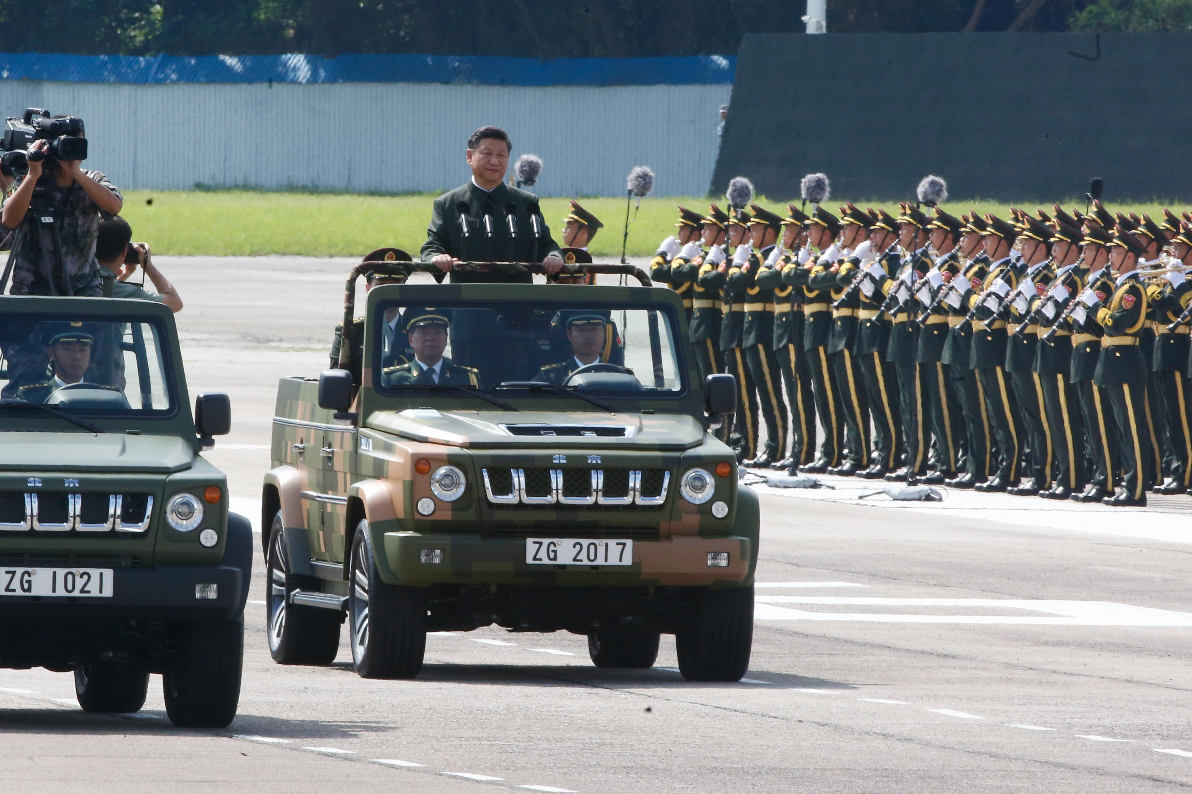 Xi Jinping, China's president, center, rides in a vehicle as he reviews People's Liberation Army (PLA) troops at the Shek Kong Barracks in Hong Kong, China, on Friday, June 30, 2017. (Billy H.C. Kwok/Bloomberg via Getty Images)