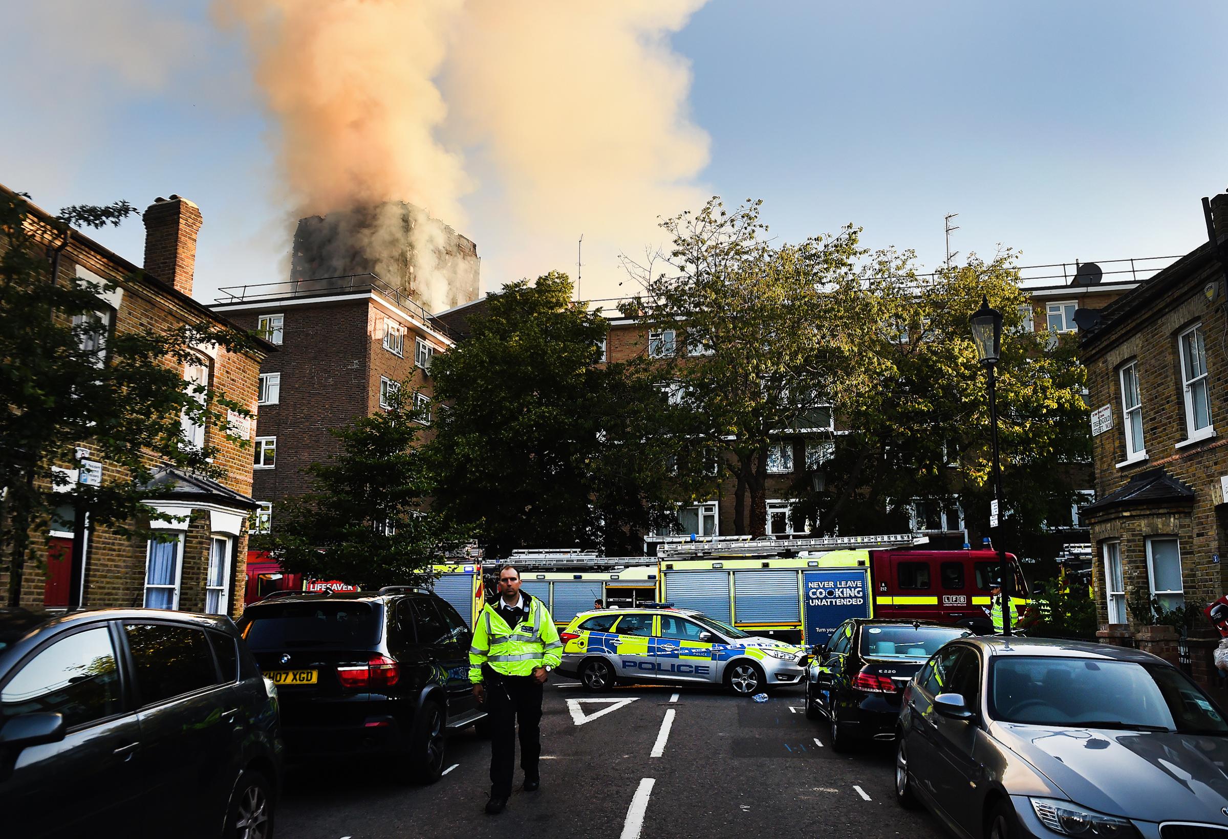 Police and rescue services operate near the fire at the Grenfell Tower apartment block in North Kensington, London, on June 14, 2017.