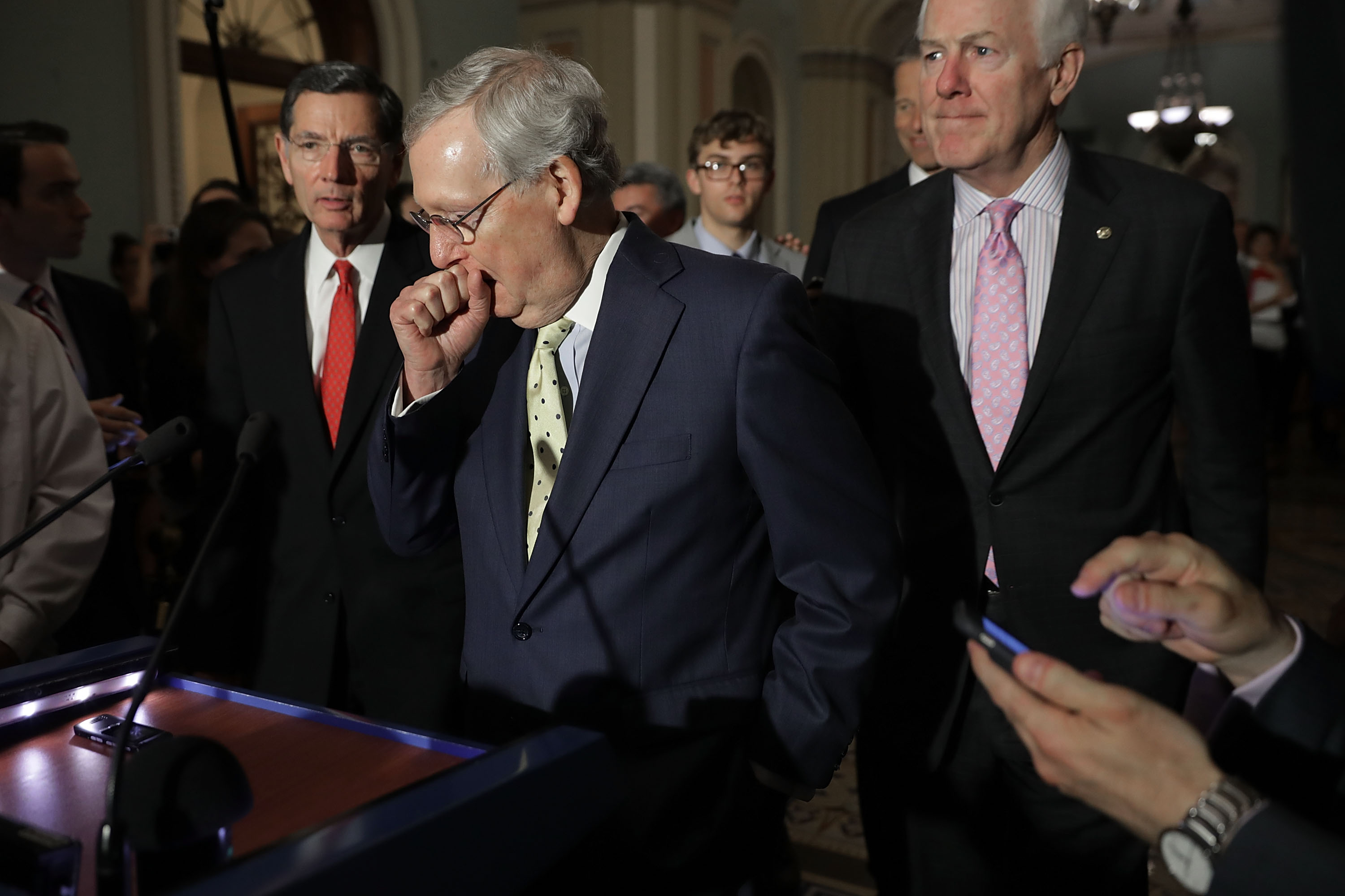 U.S. Senate Majority Leader Mitch McConnell (R-KY) (C) approaches the microphones before talking with reporters with Sen. John Barrasso (R-WY) (L) and Senate Majority Whip John Cornyn (R-TX) following the weekly GOP policy luncheon at the U.S. Capitol June 20, 2017 in Washington, D.C. (Chip Somodevilla&mdash;Getty Images)