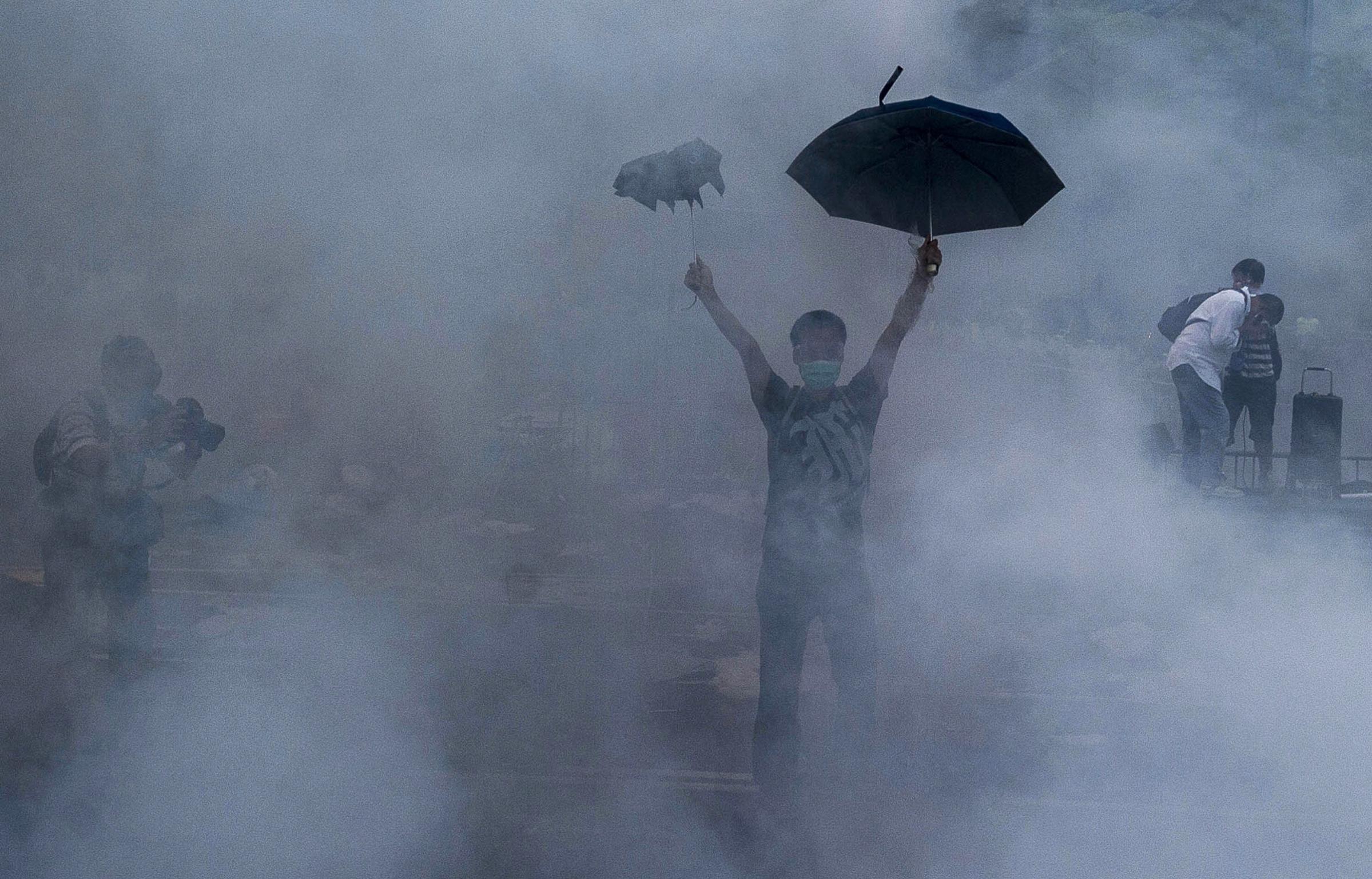 A pro-democracy demonstrator gestures after police fired tear gas towards protesters near the Hong Kong government headquarters on Sept. 28, 2014.