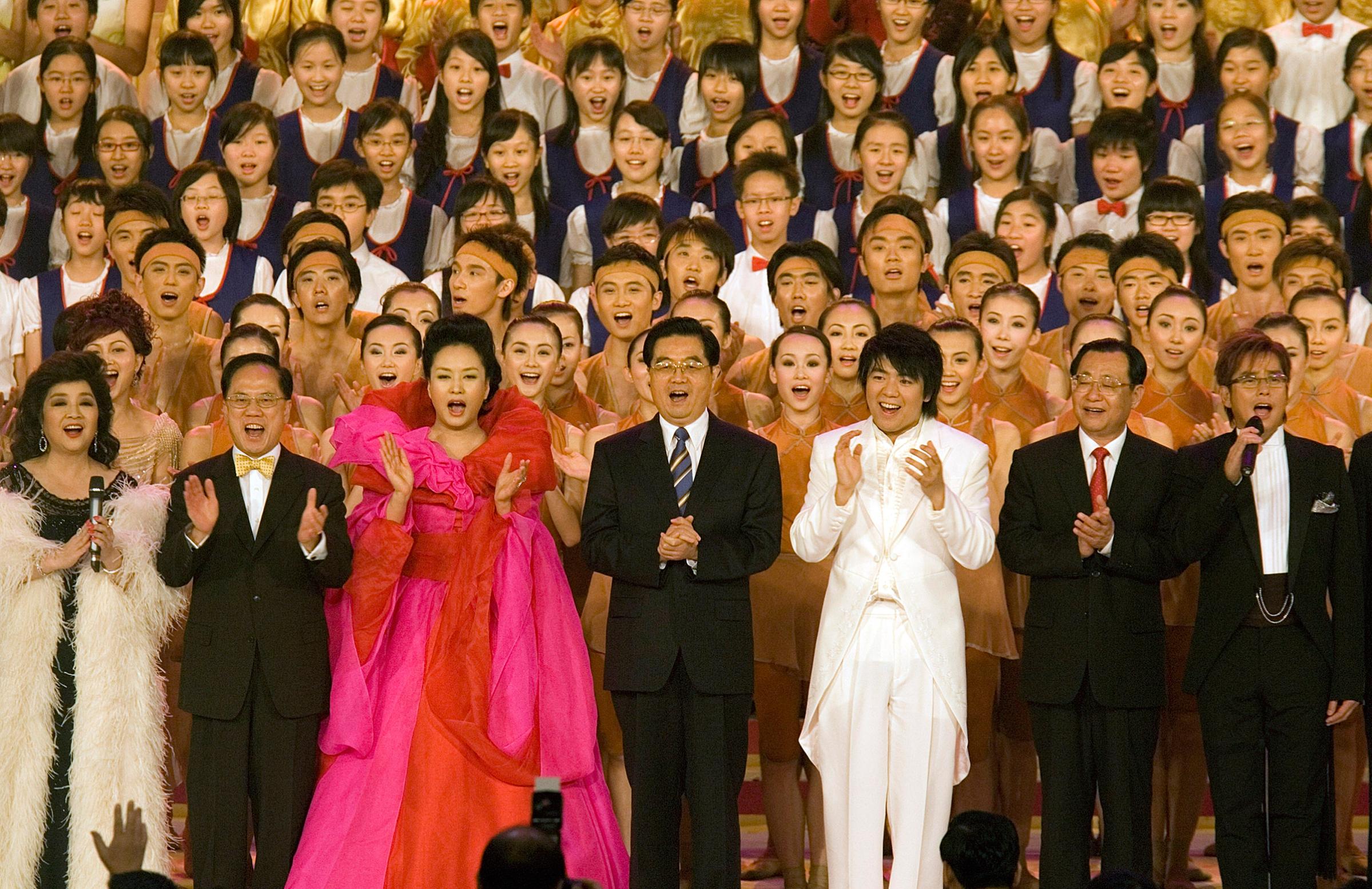 Chinese President Hu Jintao, center, sings on stage with performers at the conclusion of the Grand Variety Show in celebration of the 10th anniversary of the handover, in Hong Kong on June 30, 2007.