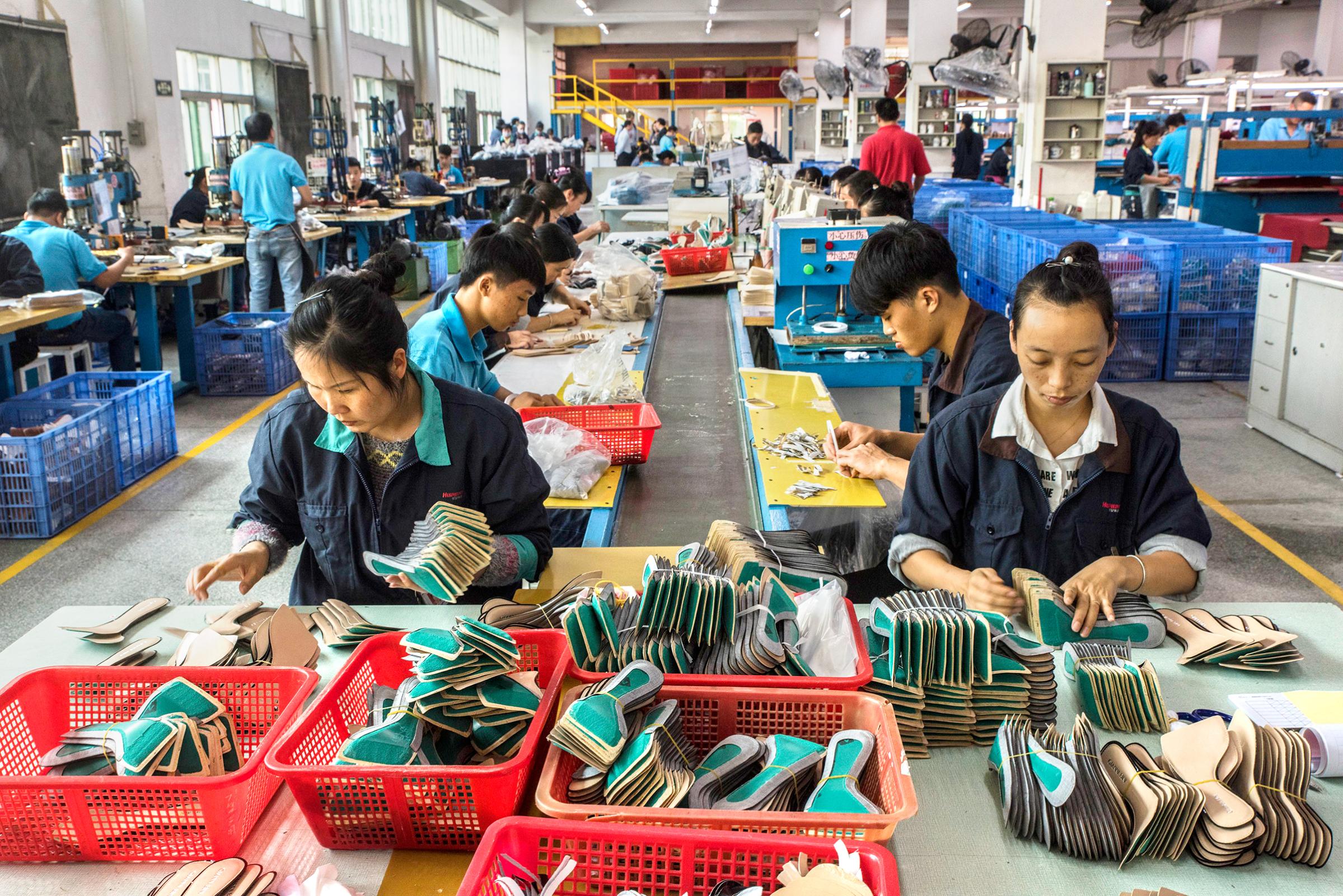Workers on an assembly line at a Huajian International shoe factory, which makes shoes for Ivanka Trump and other designers, in Dongguan, China.
