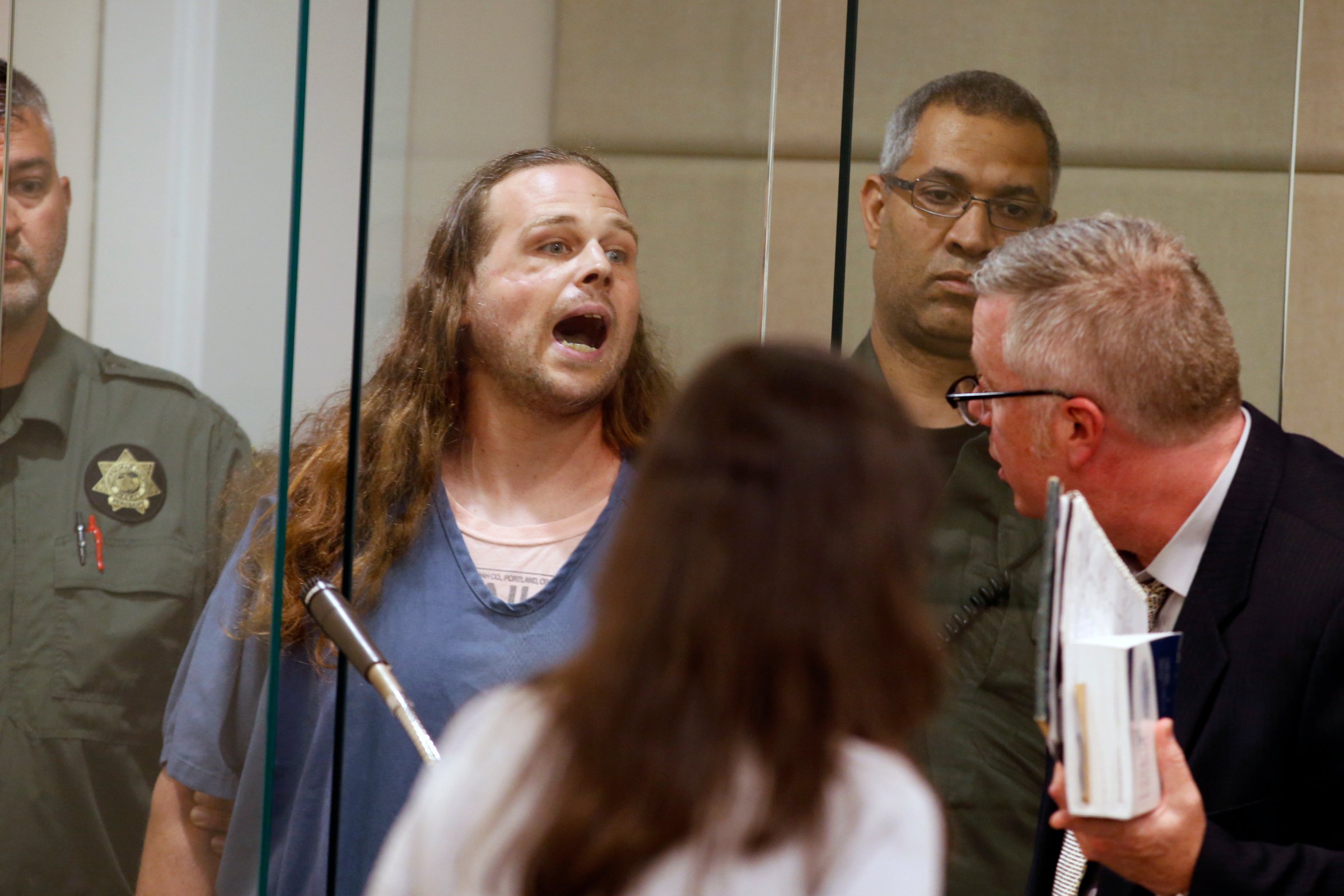 Jeremy Joseph Christian shouts as he is arraigned in Multnomah County Circuit Court in Portland, Ore., Tuesday, May 30, 2017. Authorities say Christian started verbally abusing two young women, including one wearing a hijab. When three men on the train intervened, police say, Christian attacked them, killing two and wounding one.