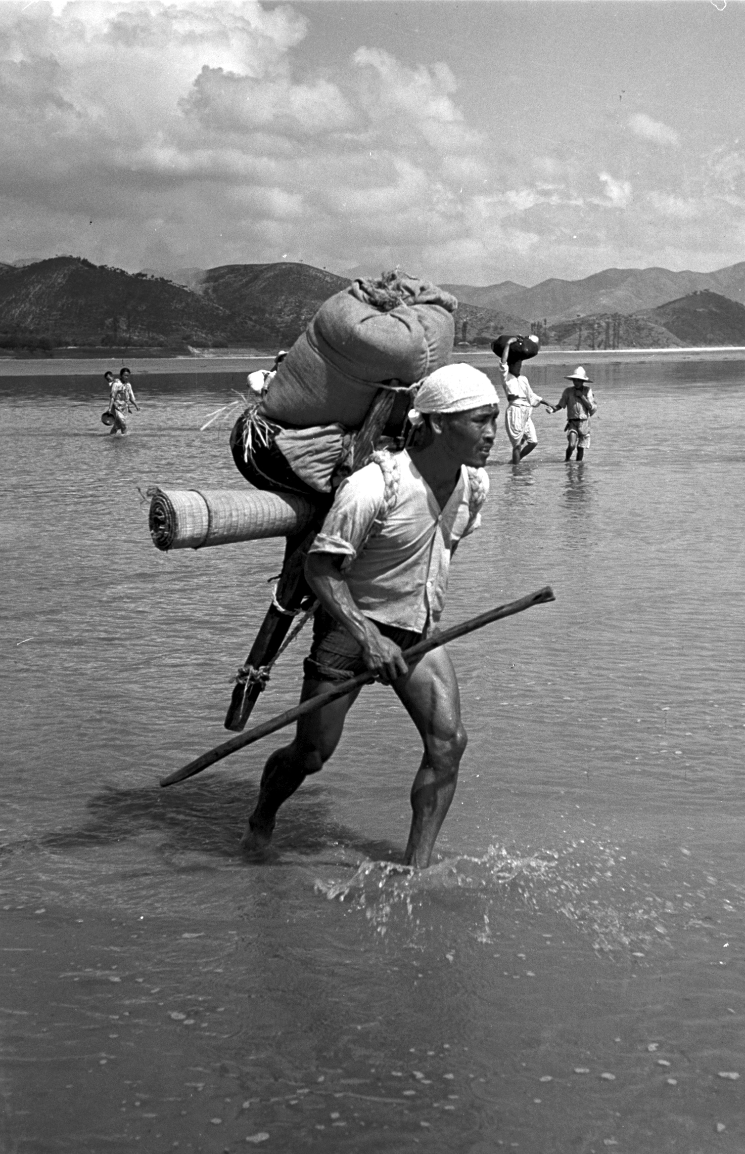 Korean refugees crossing the Naktong River during the Korean war, 1950.