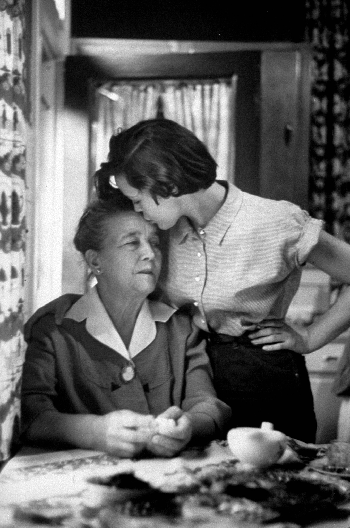 Jill Corey giving her grandmother, "Mamouch", a kiss on the forehead. 1953.
