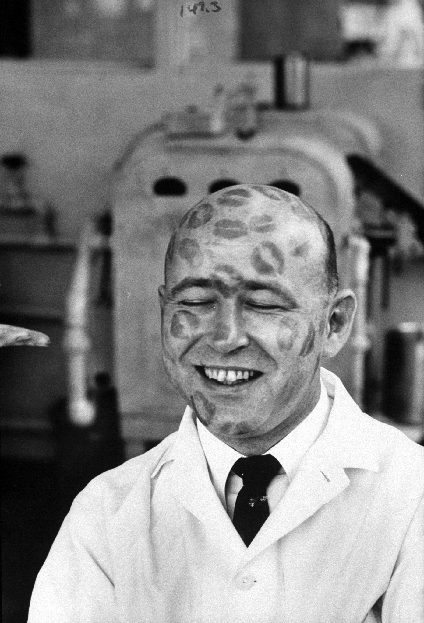 Richard Ramsey, worker in cosmetic company covered with relics of iipstick kisses to prove that dyes in lipsticks are harmless. 1960.
