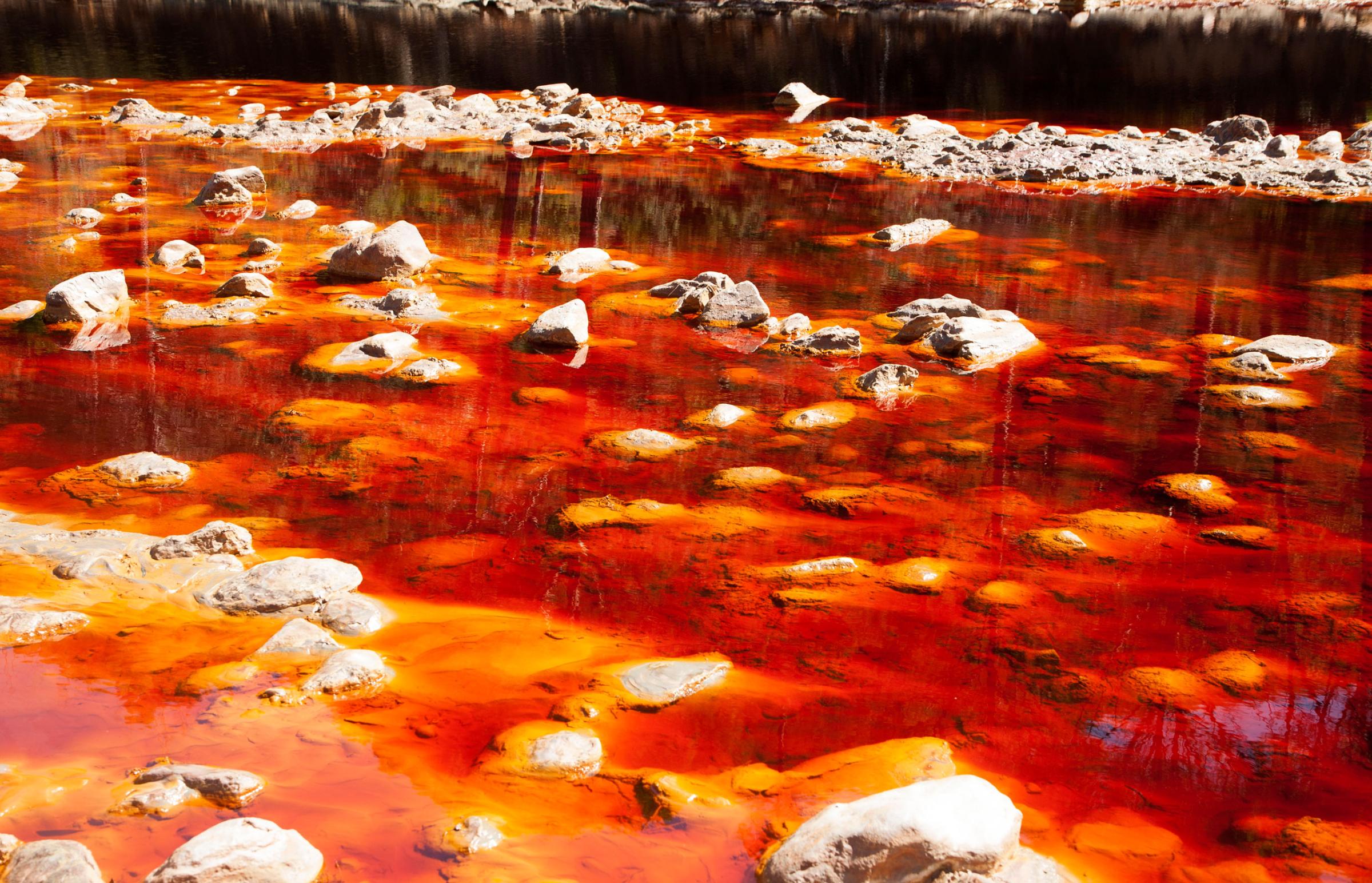 Blood red mineral laden water in the Rio Tinto river in the Minas de Riotinto mining area, Huelva province