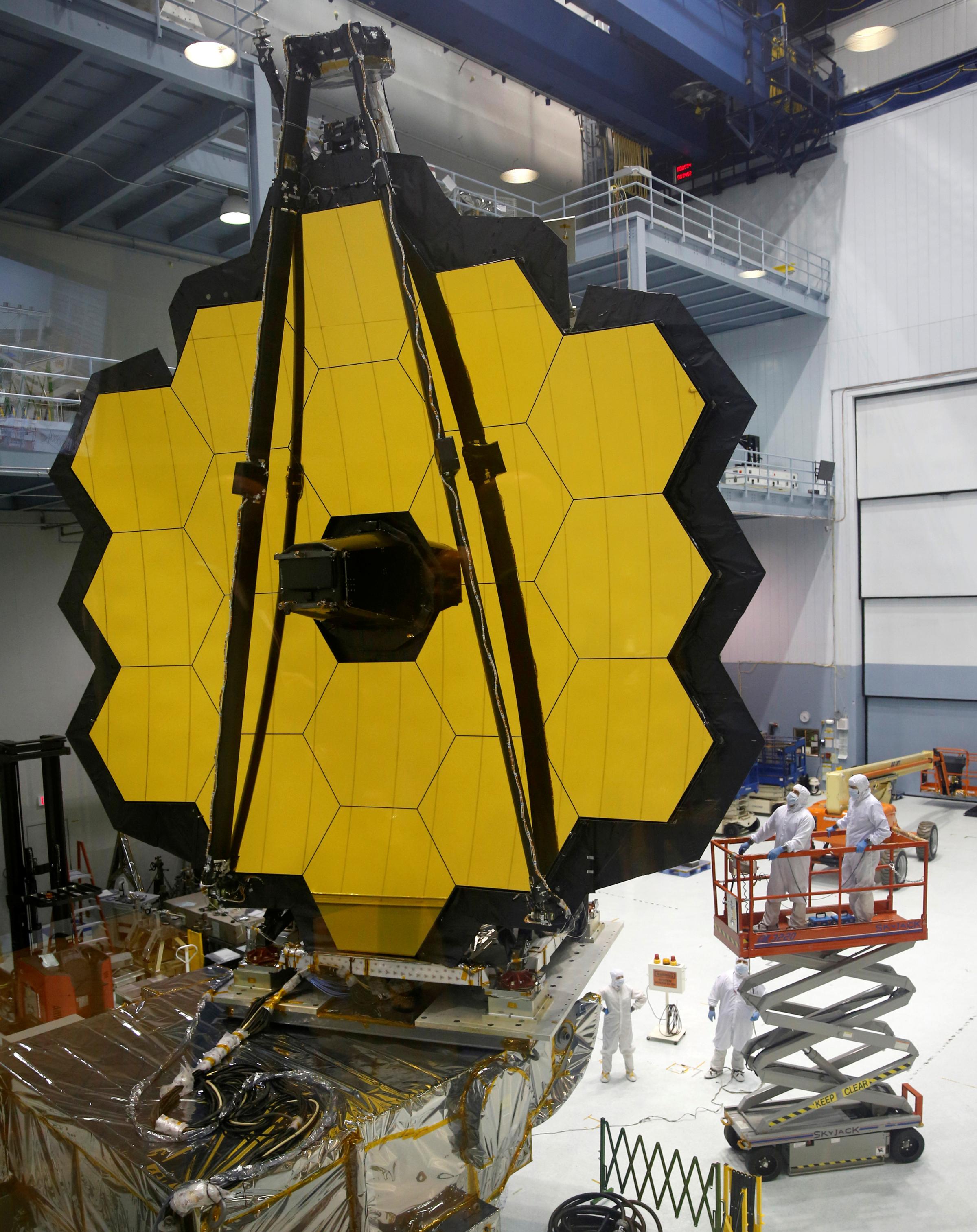 NASA workers look up at the James Webb Space Telescope Mirror during it's media reveal at NASAís Goddard Space Flight Center at Greenbelt