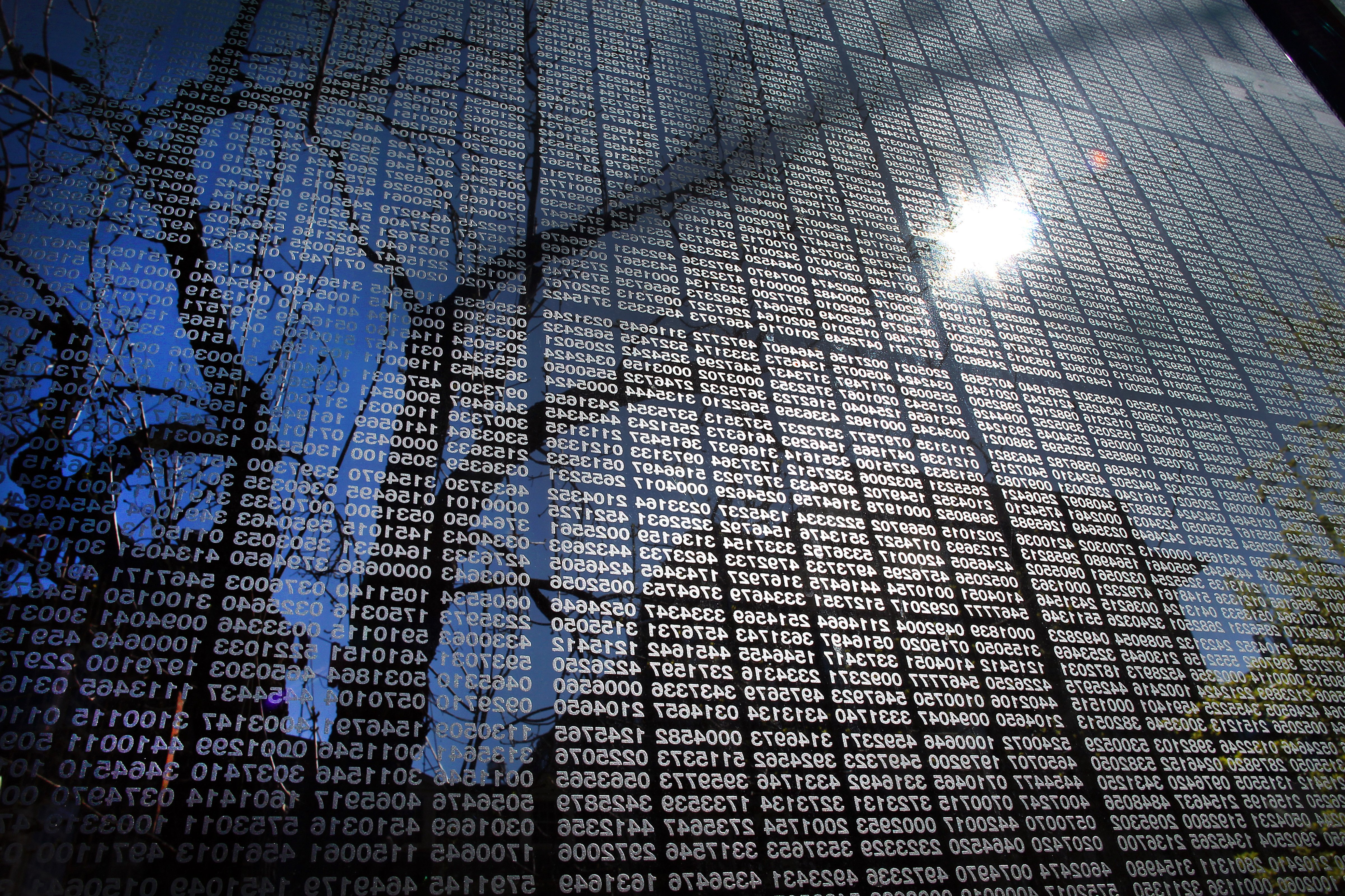 The early-morning suns shines onto the thousands of numbers of Holocaust victims on one of the glass panels at the New England Holocaust Memorial in Boston. (John Tlumacki—The Boston Globe/Getty Images)