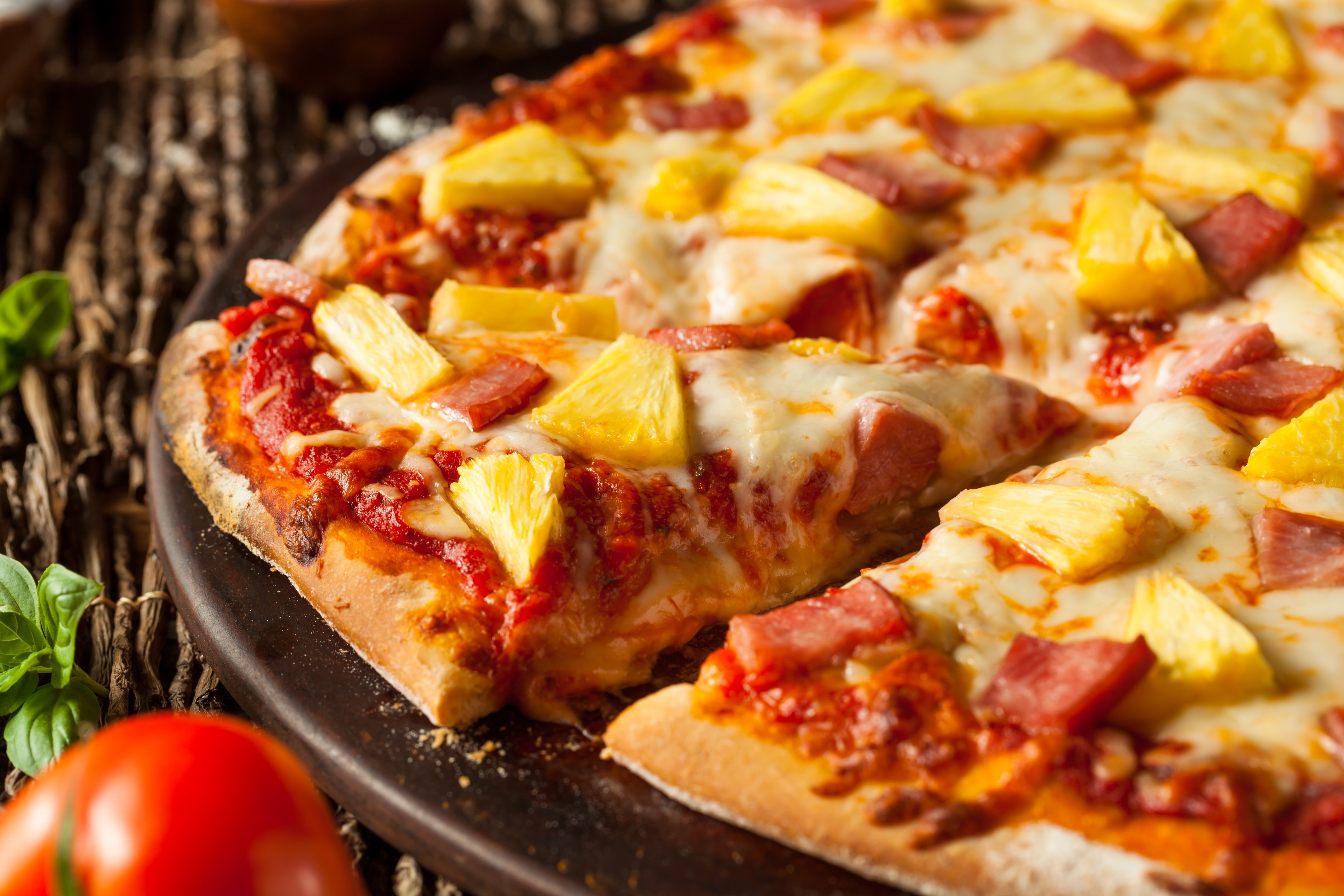 Homemade Pineapple and Ham Hawaiian Pizza Ready to Eat (bhofack2--;Getty Images/iStockphoto)