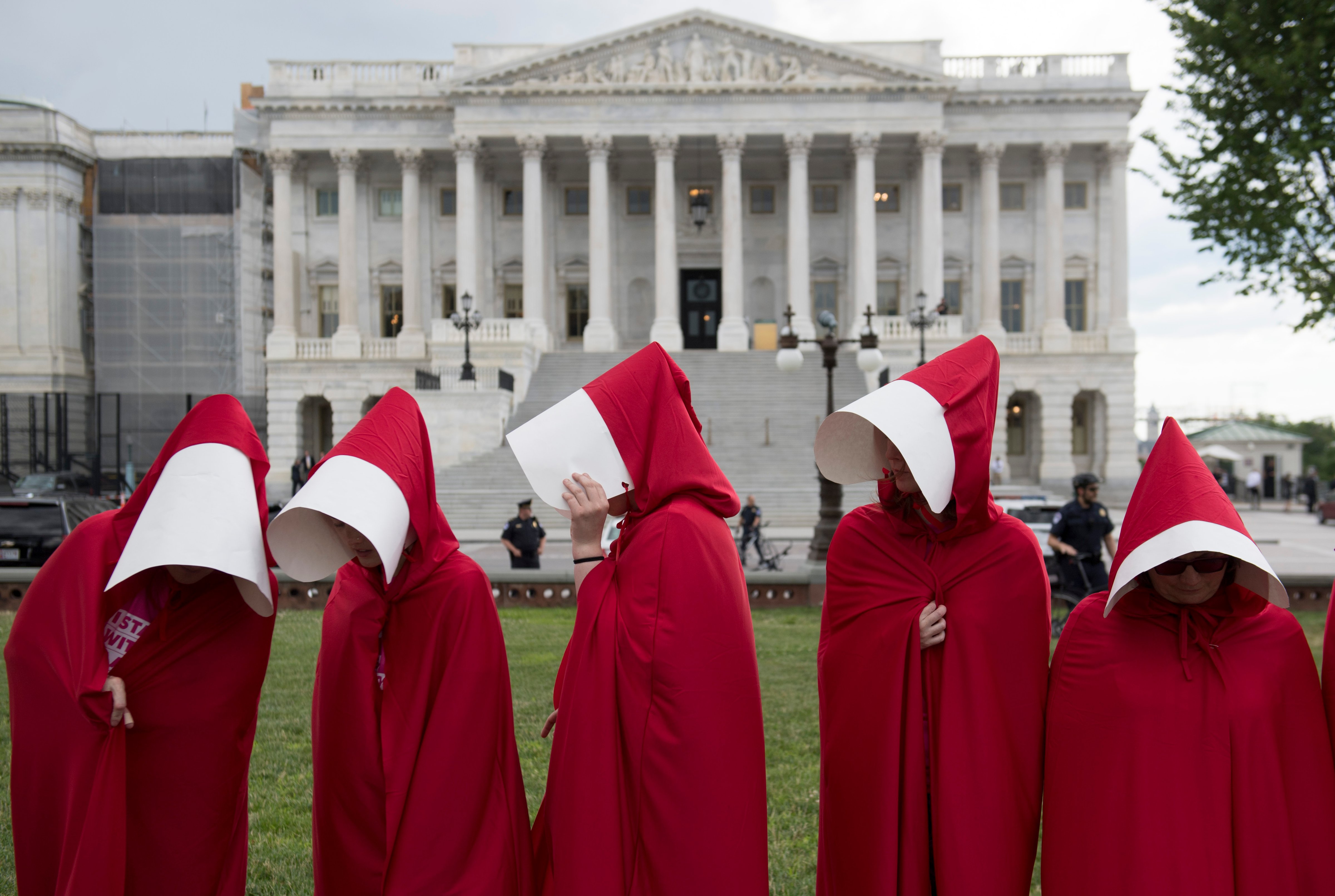 Supporters of Planned Parenthood dressed as characters from "The Handmaid's Tale," hold a rally as they protest the US Senate Republicans' healthcare bill outside the US Capitol in Washington, DC, June 27, 2017. / AFP PHOTO / SAUL LOEB        (Photo credit should read SAUL LOEB/AFP/Getty Images) (SAUL LOEB&mdash;AFP/Getty Images)