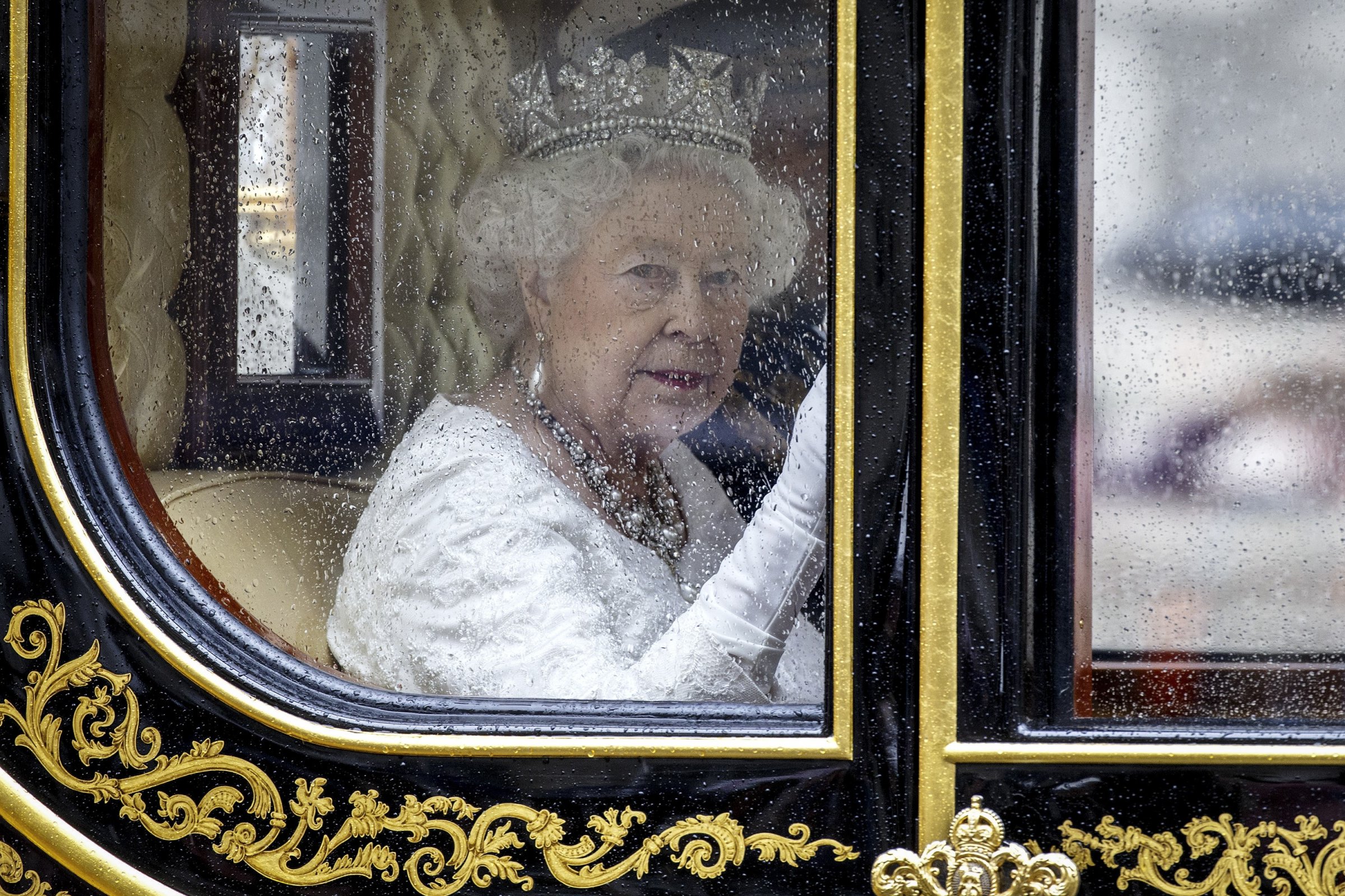 Britain's Queen Elizabeth II travels from the Houses of Parliament to Buckingham Palace after the Queen addressed the State Opening of Parliament in London, England on May 18, 2016.