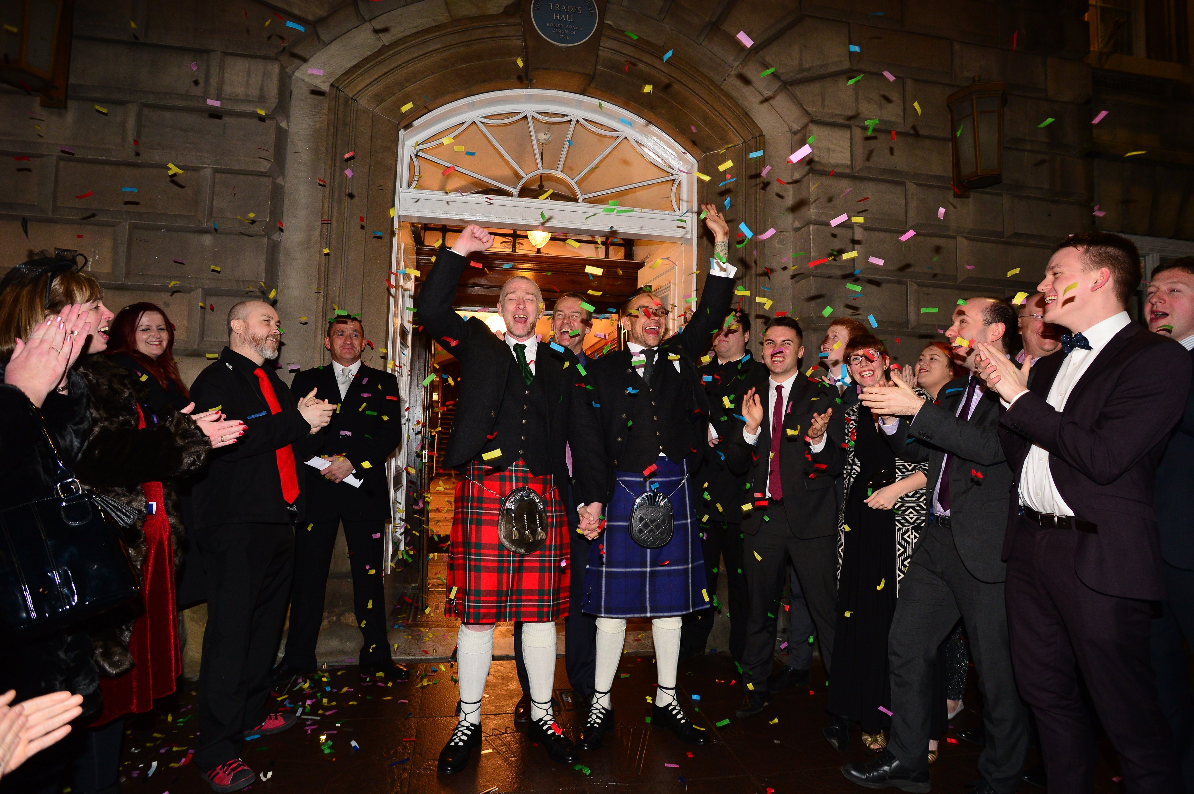 A same-sex couple Joe Schofield (blue kilt) and Malcolm Brown from Tullibody, Clackmannanshire are married shortly after midnight in front of friends and family in one of the first same-sex and belief category weddings in Scotland on Dec. 31, 2014 in Glasgow, Scotland. (Mark Runnacles—Getty Images)