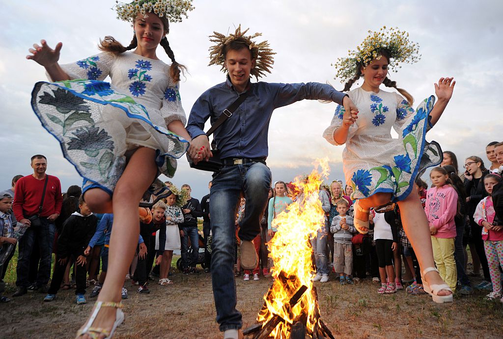 Young people jump over a bonfire as they take part in the Ivan Kupala Night celebration, a traditional Slavic holiday, outside the small town of Turov, on July 6, 2016. (SERGEI GAPON&mdash;AFP/Getty Images)
