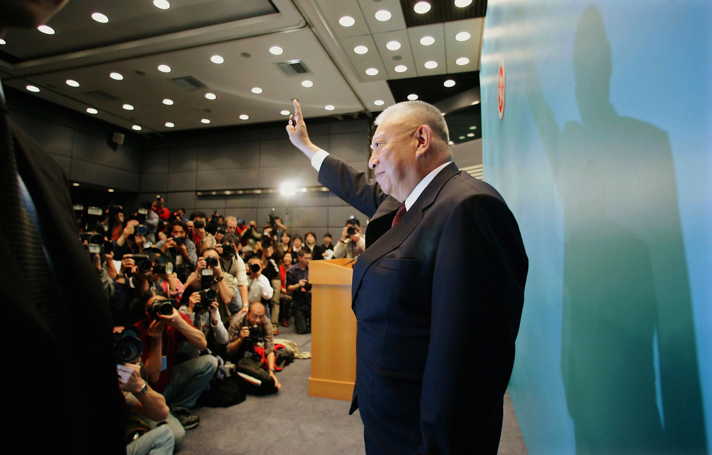 Hong Kong Chief Executive Tung Chee-hwa leaves a news conference after announcing his resignation on March 10, 2005. Tung cited health reasons for cutting short an eight-year tenure plagued by economic recession, policy blunders and unease over China's interference.